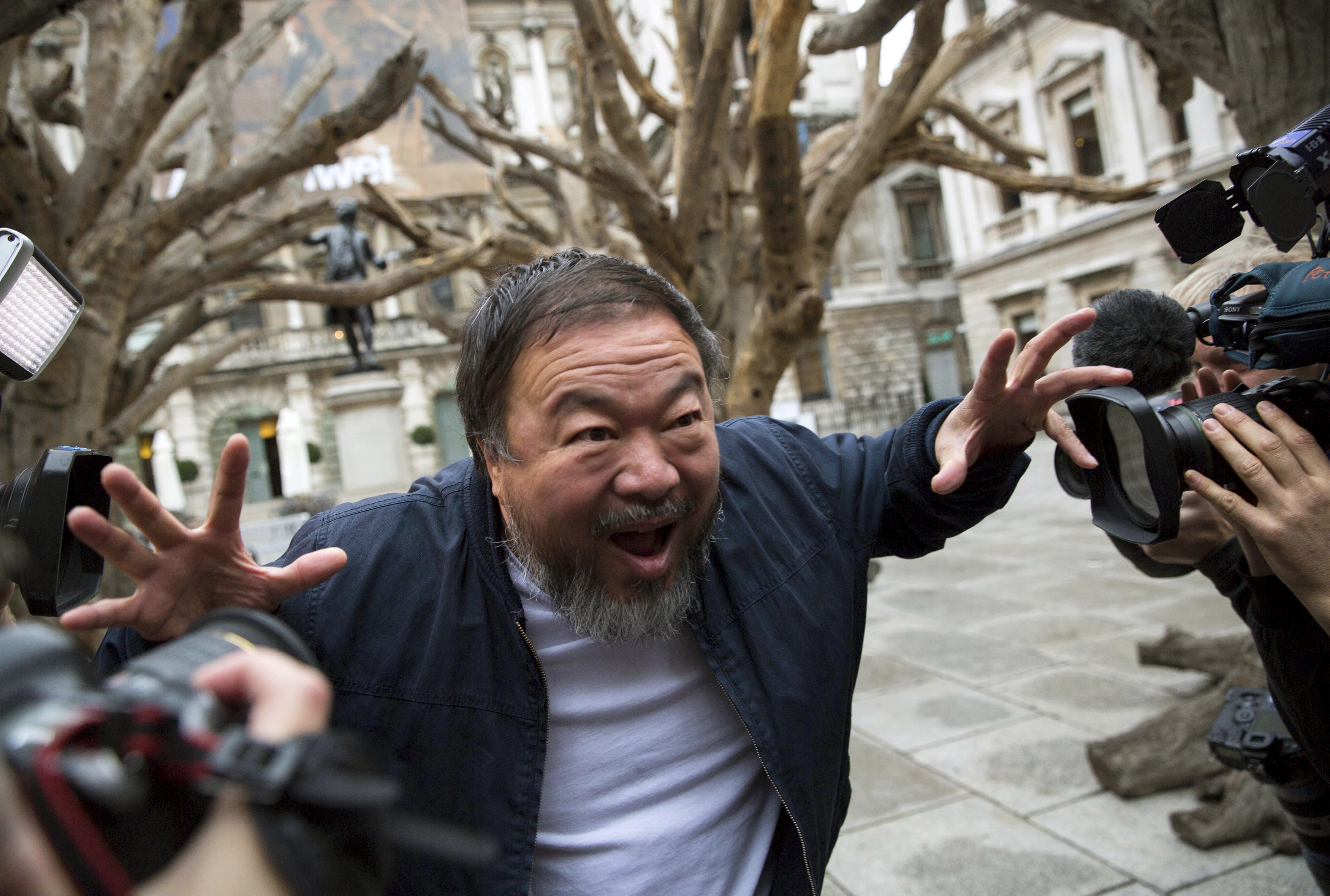 Chinese artist Ai Weiwei poses for photographers during a photocall for his exhibition at the Royal Academy of Arts in London, Britain September 15, 2015. REUTERS/Neil Hall TPX IMAGES OF THE DAY