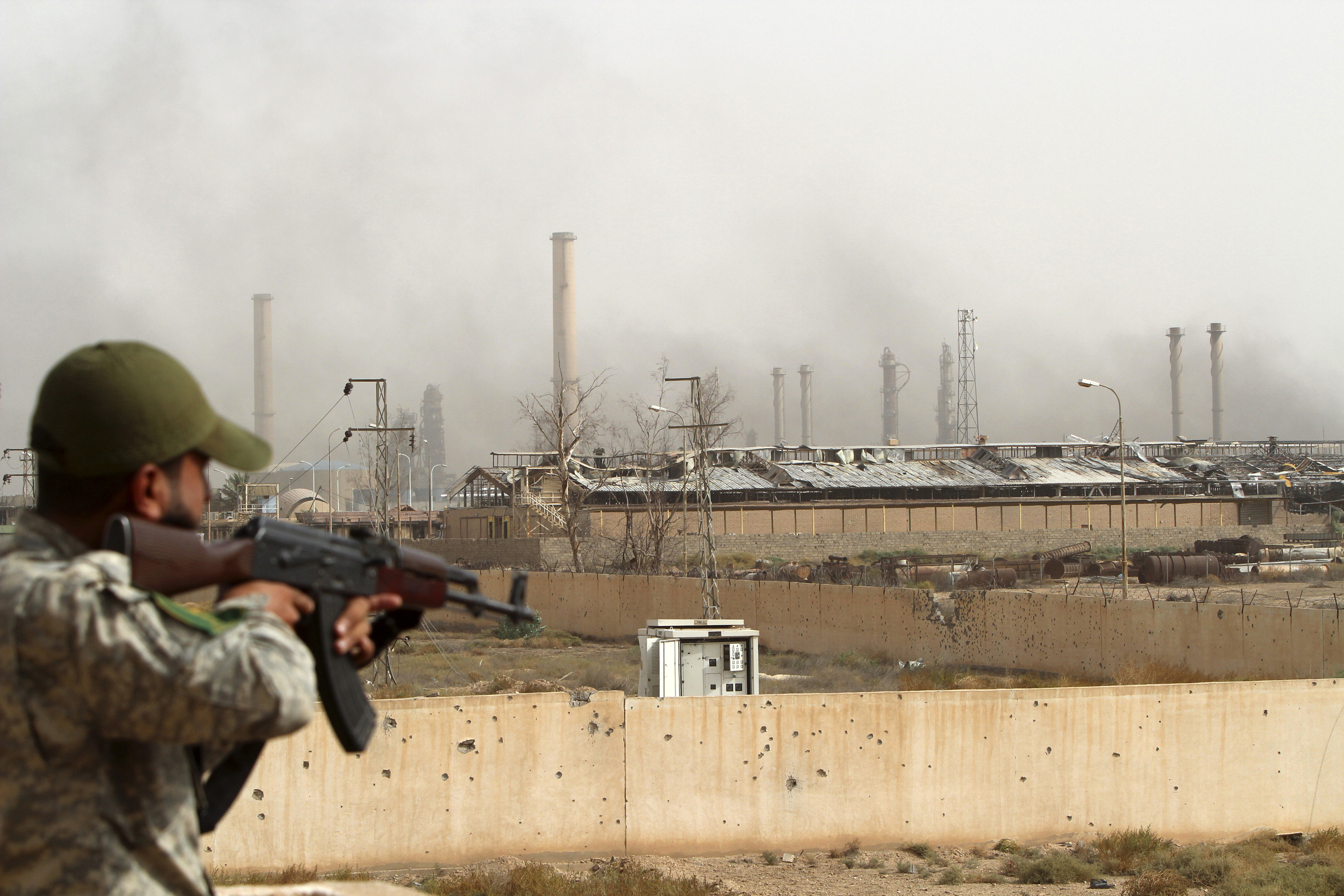 A member with Popular Mobilization Forces searches Beiji oil refinery, some 250 kilometers (155 miles) north of Baghdad, Iraq, Thursday, Oct. 22, 2015. Coalition officials said that Iraqi security forces, backed by the paramilitary Popular Mobilization Forces and Iraqi federal police, and supported by airstrikes, continue to work to recapture and clear the western city of Ramadi and the city of Beiji, home to Iraq’s largest oil refinery. (AP Photo)