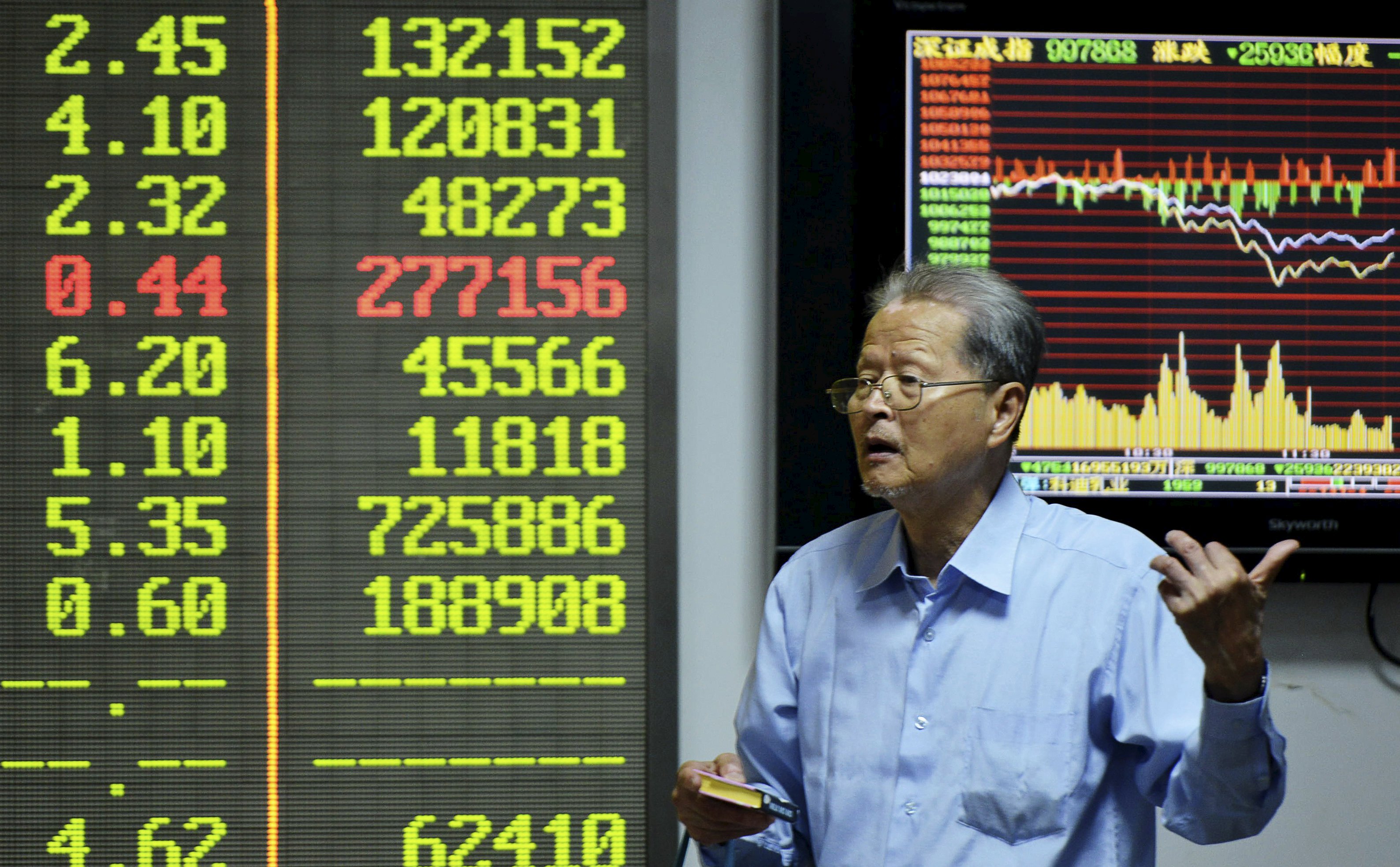 A man speaks to another investor in front of an electronic board showing stock information at a brokerage house in Hangzhou, Zhejiang province, China, September 25, 2015. China stocks fell on Friday, led by a selloff in small caps, as the main indexes ended the week roughly flat in shrinking trading volume. REUTERS/China Daily CHINA OUT. NO COMMERCIAL OR EDITORIAL SALES IN CHINA