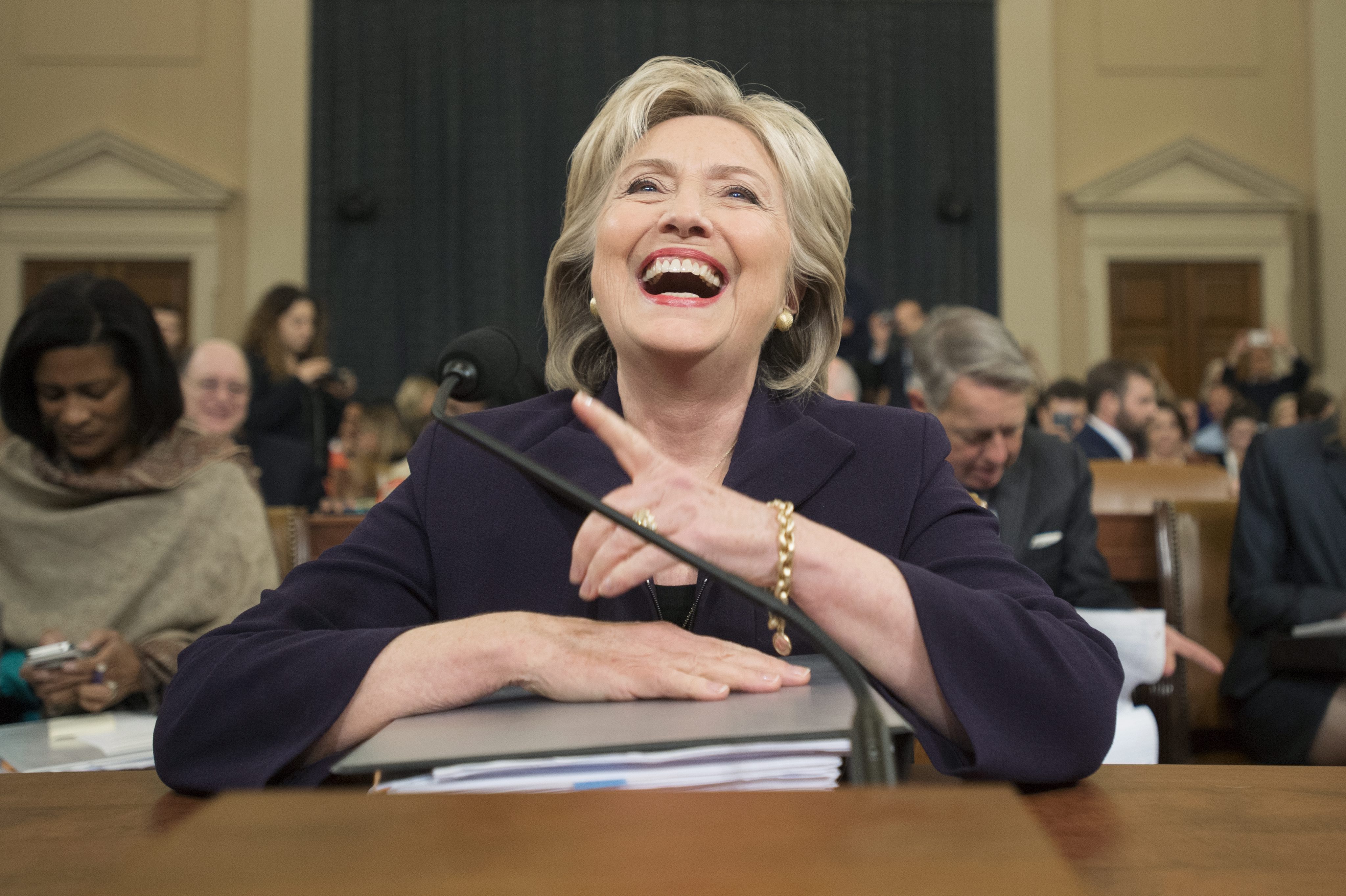 epa04990239 Former Secretary of State and Democratic presidential candidate Hillary Clinton laughs after returning from a break in testifying at the House Select Committee on Benghazi, on Capitol Hill in Washington DC, USA, 22 October 2015. Clinton faces scrutiny over her response to the the 11 September 2012 attack on the US diplomatic compound in Benghazi, Libya; and her use of a private email server while holding the position of Secretary of State. EPA/MICHAEL REYNOLDS