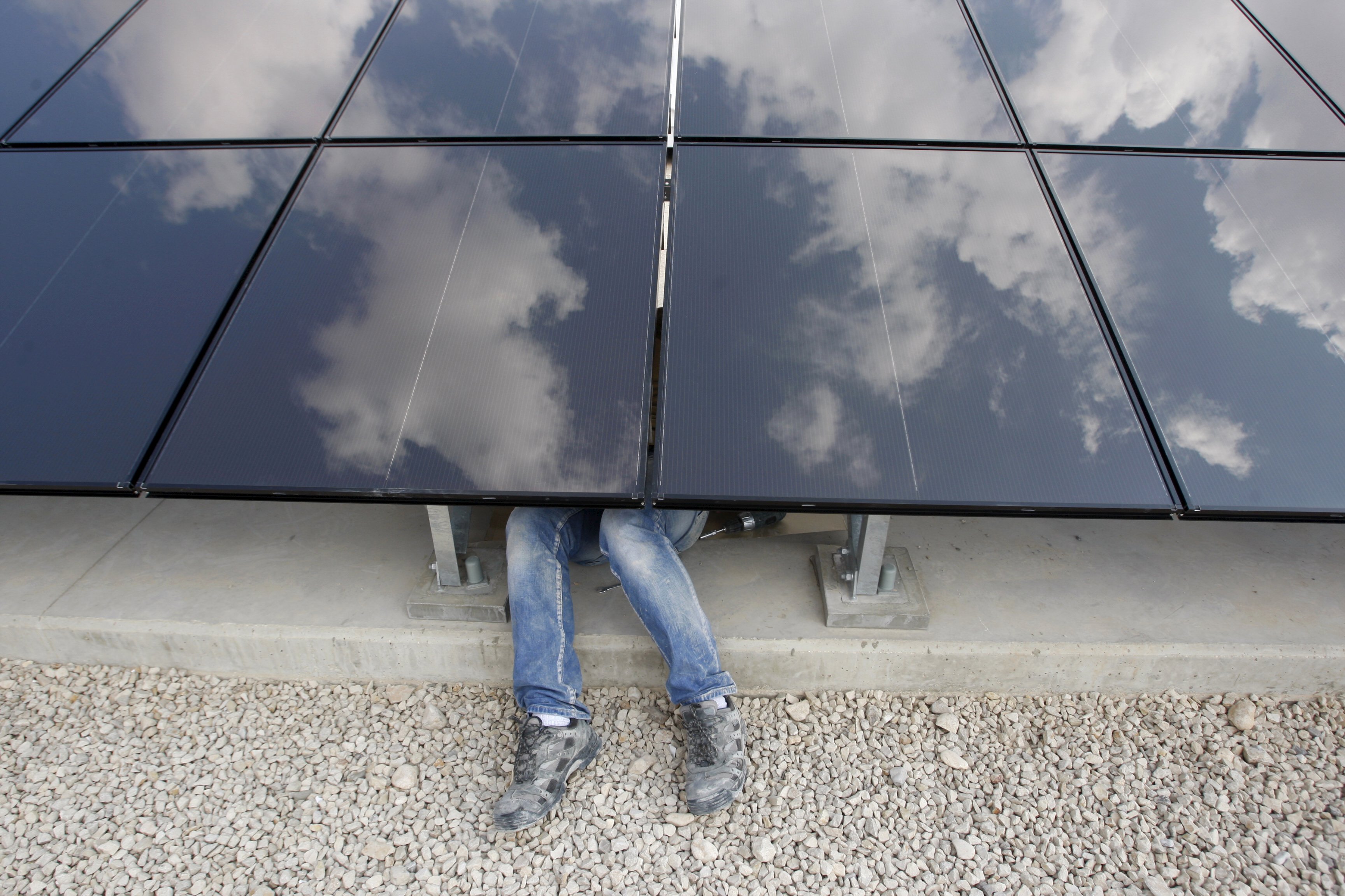 A Palestinian labourer installs solar panels at a photovoltaic plant in the West Bank city of Jericho in this March 27, 2012 file photo. Renewables are powering a rare bright spot in the energy industry, with record job hiring in solar, wind and hydro partly offsetting the biggest round of job losses in the oil and gas sector in almost two decades. The fresh opportunities come as the oil sector is suffering its worst downturn since the late 1990s, encouraging engineering students to rethink their options and even mid-career switches for some who have spent more than a decade in the oil sector. REUTERS/Mohamad Torokman/Files