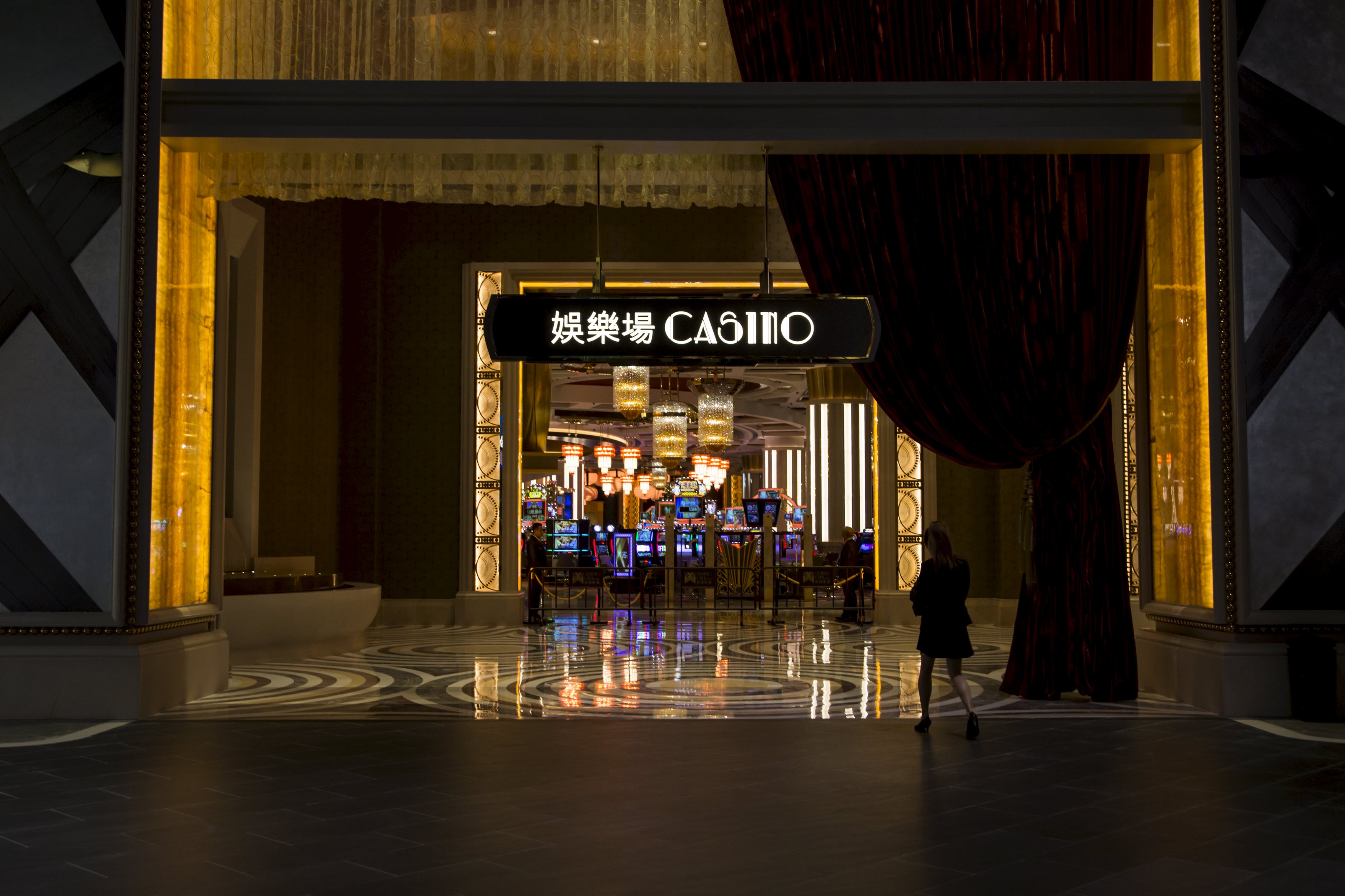 A woman walks in front of a casino at Studio City in Macau, China, October 27, 2015. Melco Crown’s Hollywood-themed Studio City is the company’s third casino in the southern Chinese territory of Macau, the only place in the country where casino gambling is legal. Studio City represents a break from the other 37 casinos operating in Macau. It has no VIP baccarat lounges and will focus instead on mass-market casual gamblers, in a sign of the times for the world's largest gambling hub. REUTERS/Tyrone Siu