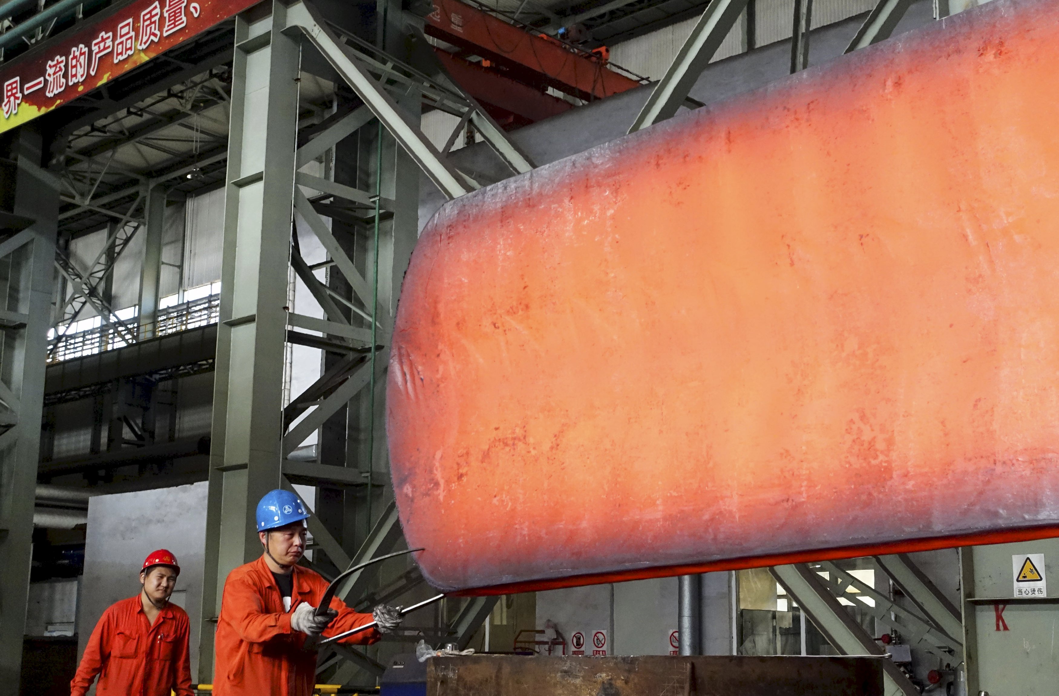 A worker measures a newly-made steel block at a factory of Dongbei Special Steel Group Co., Ltd., in Dalian, Liaoning province, China, October 13, 2015. China's economic growth is expected to fall below 7 percent for the first time since the global financial crisis in the third quarter, putting pressure on policymakers to roll out more support measures as fears of a sharper slowdown spook investors. Picture taken October 13, 2015. REUTERS/China Daily CHINA OUT. NO COMMERCIAL OR EDITORIAL SALES IN CHINA. TPX IMAGES OF THE DAY.