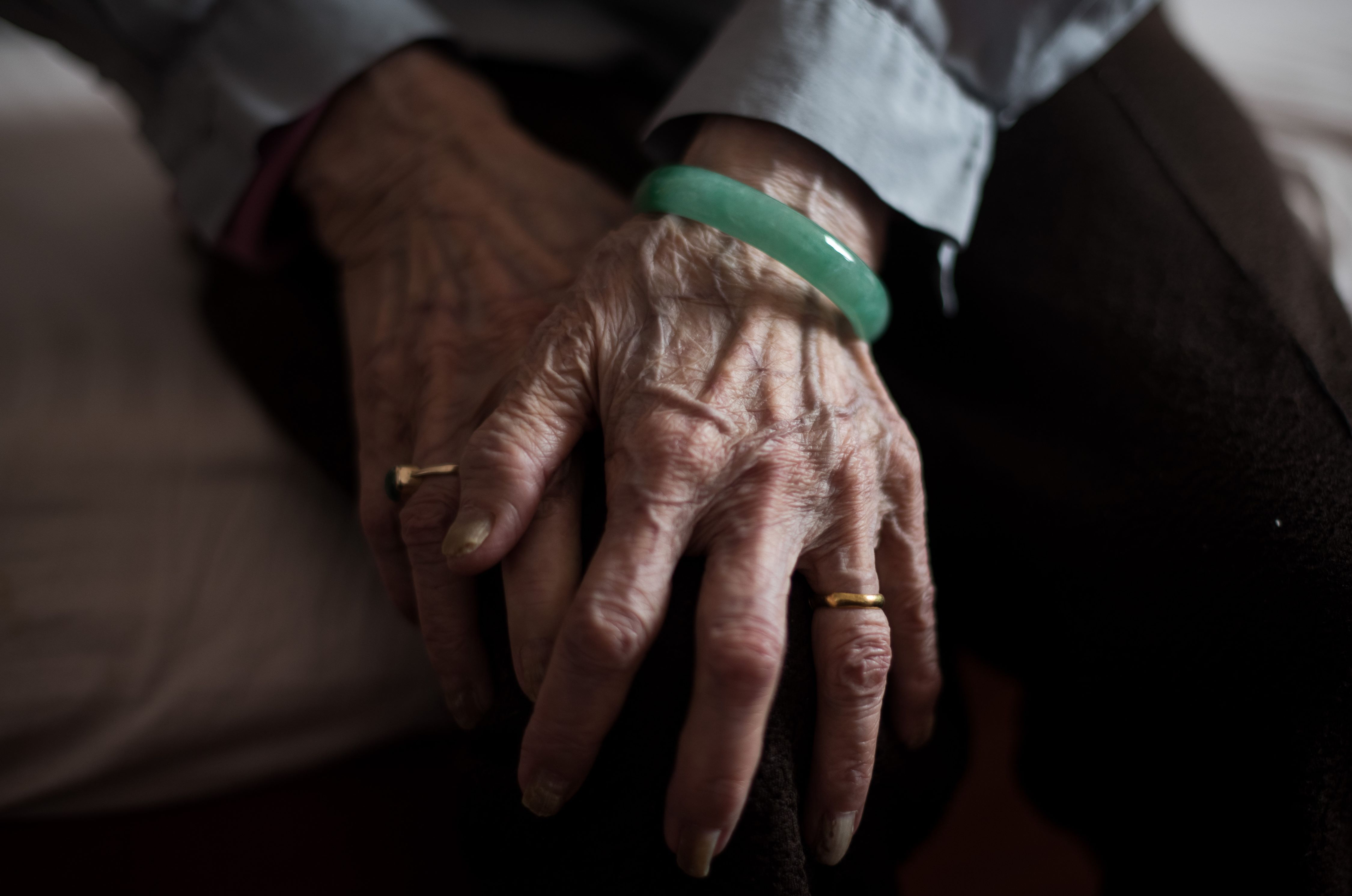 This picture taken on June 1, 2015 shows the hands of an elderly Chinese lady as she rests at a care home in Shanghai. China abandoned its decades-old one-child policy on October 29 to confront a looming slump in the economy and is unlikely to work in rebalancing China’s ageing population, because China like everywhere else is looking at a low birth rate especially among affluent, well-educated women. AFP PHOTO / JOHANNES EISELE