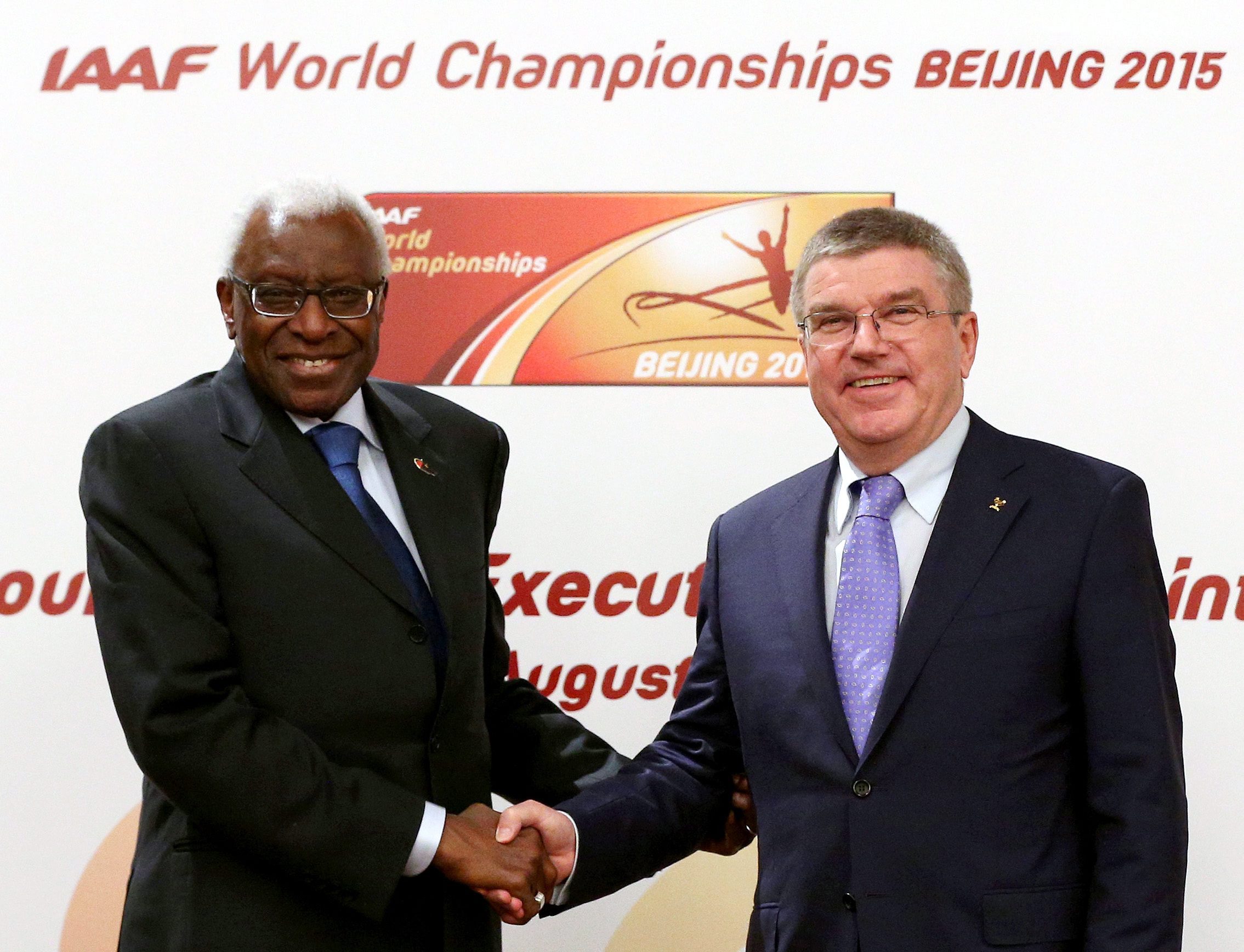 epa05018125 (FILE) A file picture dated 21 August 2015 of President of the International Olympic Committee (IOC), Thomas Bach shaking hands with IAAF President Lamine Diack (L) after a press conference after the IAAF Council and IOC Executive Board meeting at Intercontinental Beijing Beichen Hotel in Beijing city, China. The ethics commission of the International Olympic Committee (IOC) recommended the provisional suspension of former athletics governing body IAAF president Lamine Diack as an honorary member on 09 Novemer 2015. EPA/WU HONG