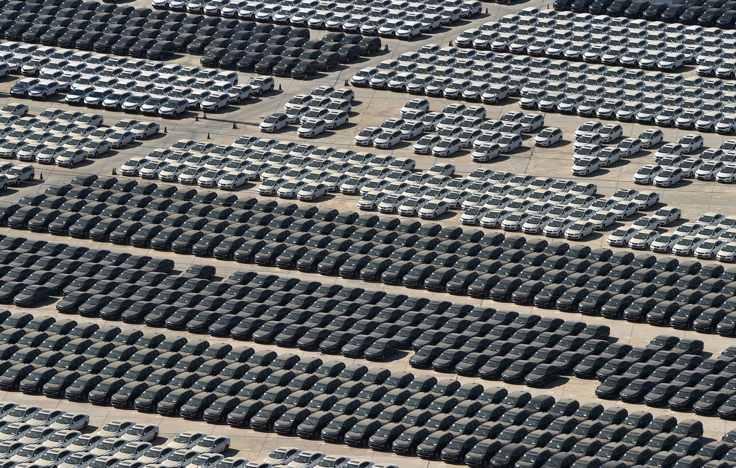 New vehicles are seen at a parking area of an automobile factory in Wuhan, Hubei province, August 1, 2015. Automakers in China may be forced to come up with more drastic mitigation measures when July sales results released from this week likely reveal a fourth month of contraction after a stock market crash sapped consumer sentiment. Picture taken August 1, 2015. REUTERS/China Daily CHINA OUT. NO COMMERCIAL OR EDITORIAL SALES IN CHINA