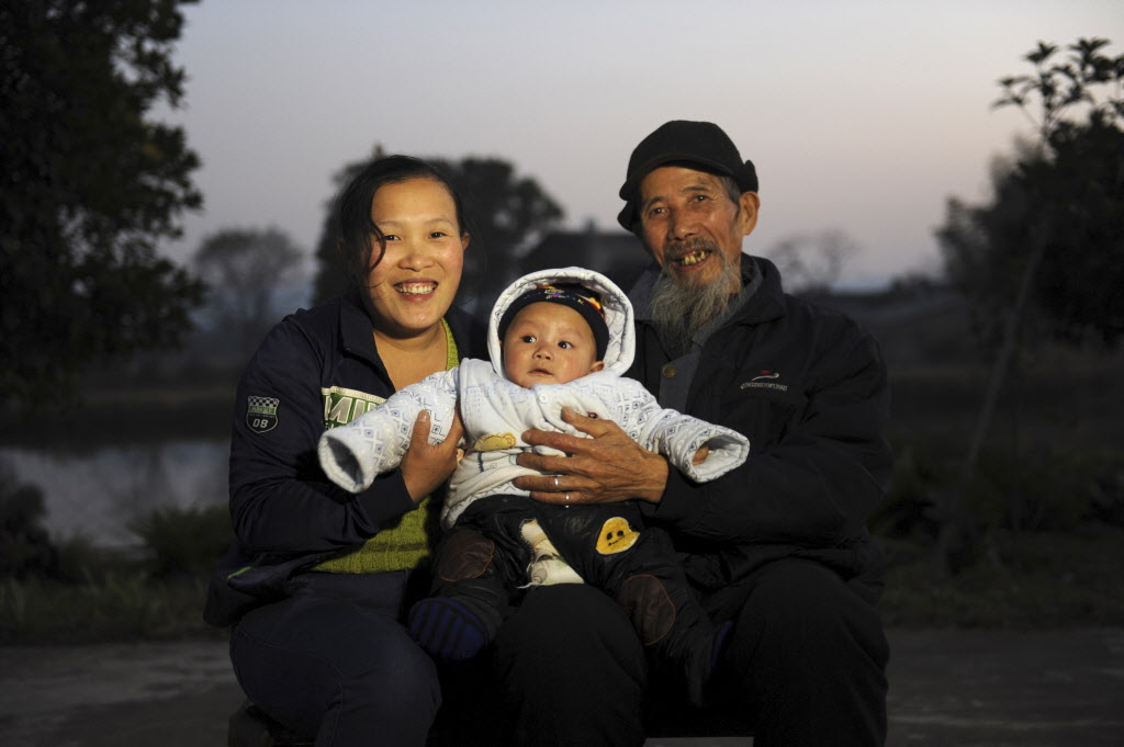 Wen Changlin and Zhang Feng pose for a picture with their son at home in Ningxiang county of Changsha, Hunan province, in this December 2, 2013 file photo. China will ease family planning restrictions to allow all couples to have two children after decades of a strict one-child policy, the ruling Communist Party said on October 29, 2015, a move aimed at alleviating demographic strains on the economy. REUTERS/Stringer/Files CHINA OUT. NO COMMERCIAL OR EDITORIAL SALES IN CHINA TPX IMAGES OF THE DAYFROM THE FILES - "CHINA'S TWO CHILD POLICY"SEARCH "TWO CHILD" FOR ALL 14 IMAGES