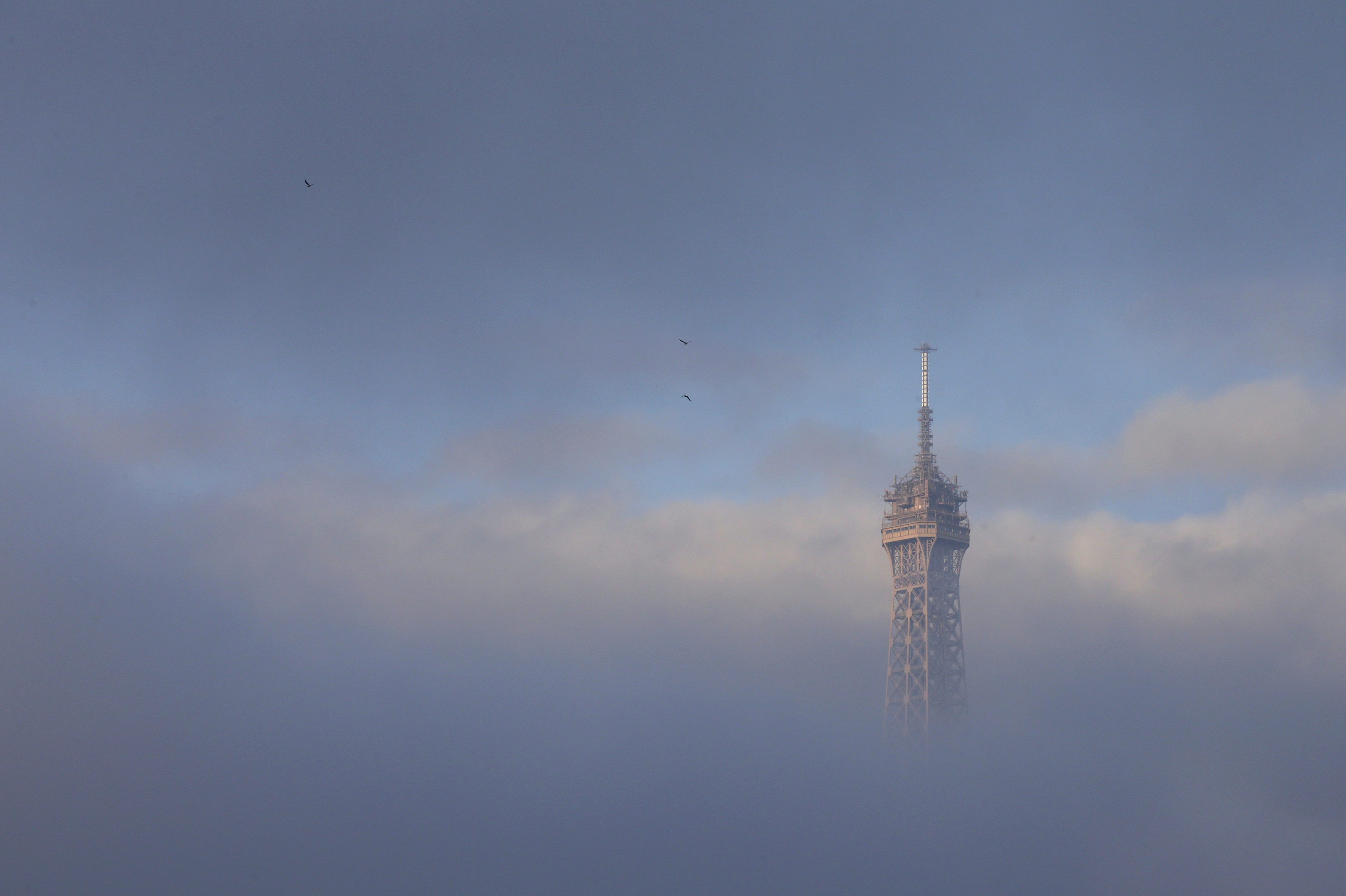 The Eiffel Tower is partially covered by an early morning fog in Paris, France, November 27, 2015 as the capital will host the World Climate Change Conference 2015 (COP21) from November 30 to December 11. REUTERS/Philippe Wojazer TPX IMAGES OF THE DAY