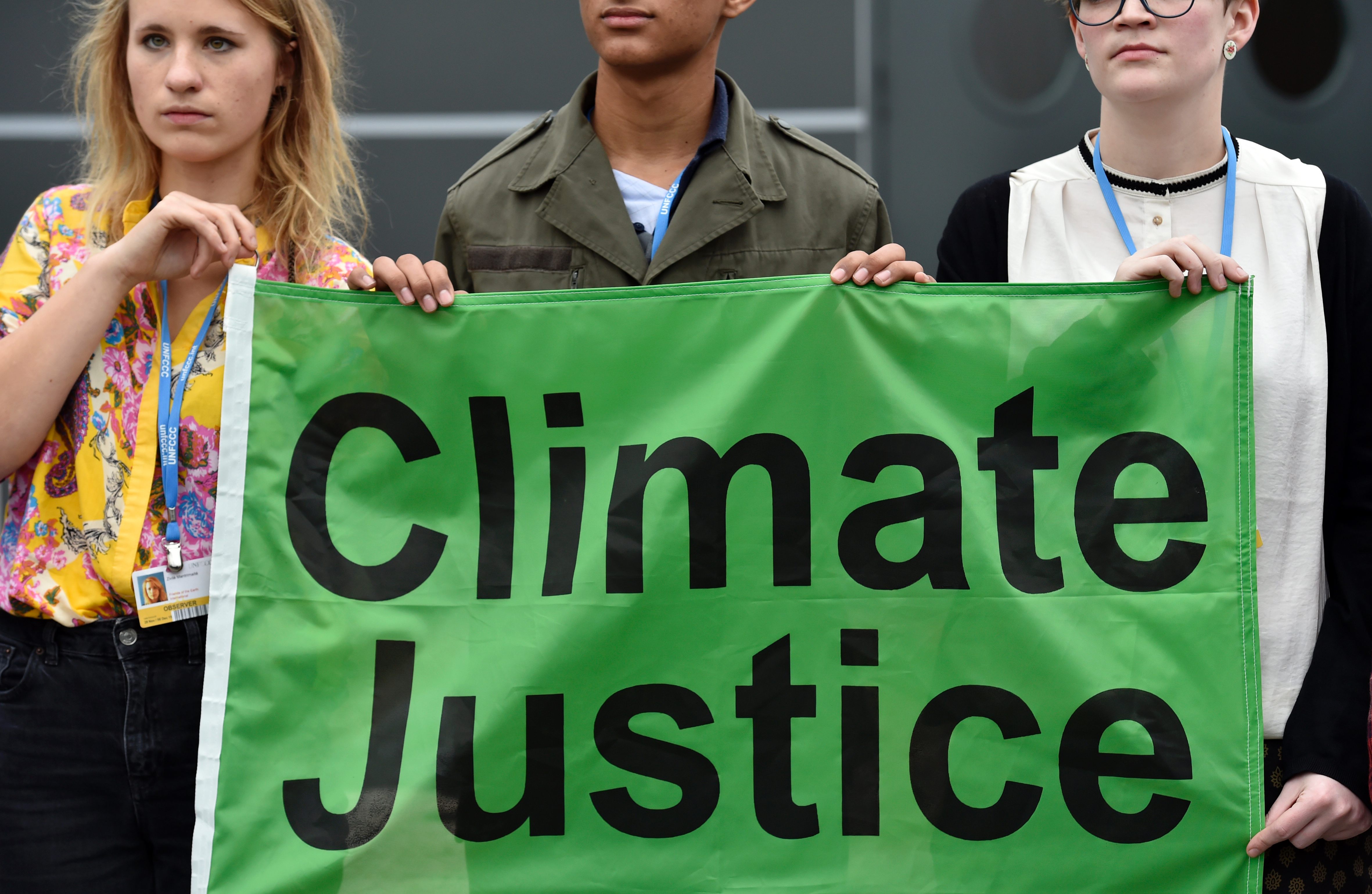 Members of Non-Governmental Organisation "Friends of the Earth" demonstrate during the United Nations conference on climate change COP21, on December 1, 2015 at Le Bourget, on the outskirts of French capital Paris. More than 150 world leaders are meeting under heightened security, for the 21st Session of the Conference of the Parties to the United Nations Framework Convention on Climate Change (COP21/CMP11), also known as “Paris 2015” from November 30 to December 11. / AFP / LOIC VENANCE