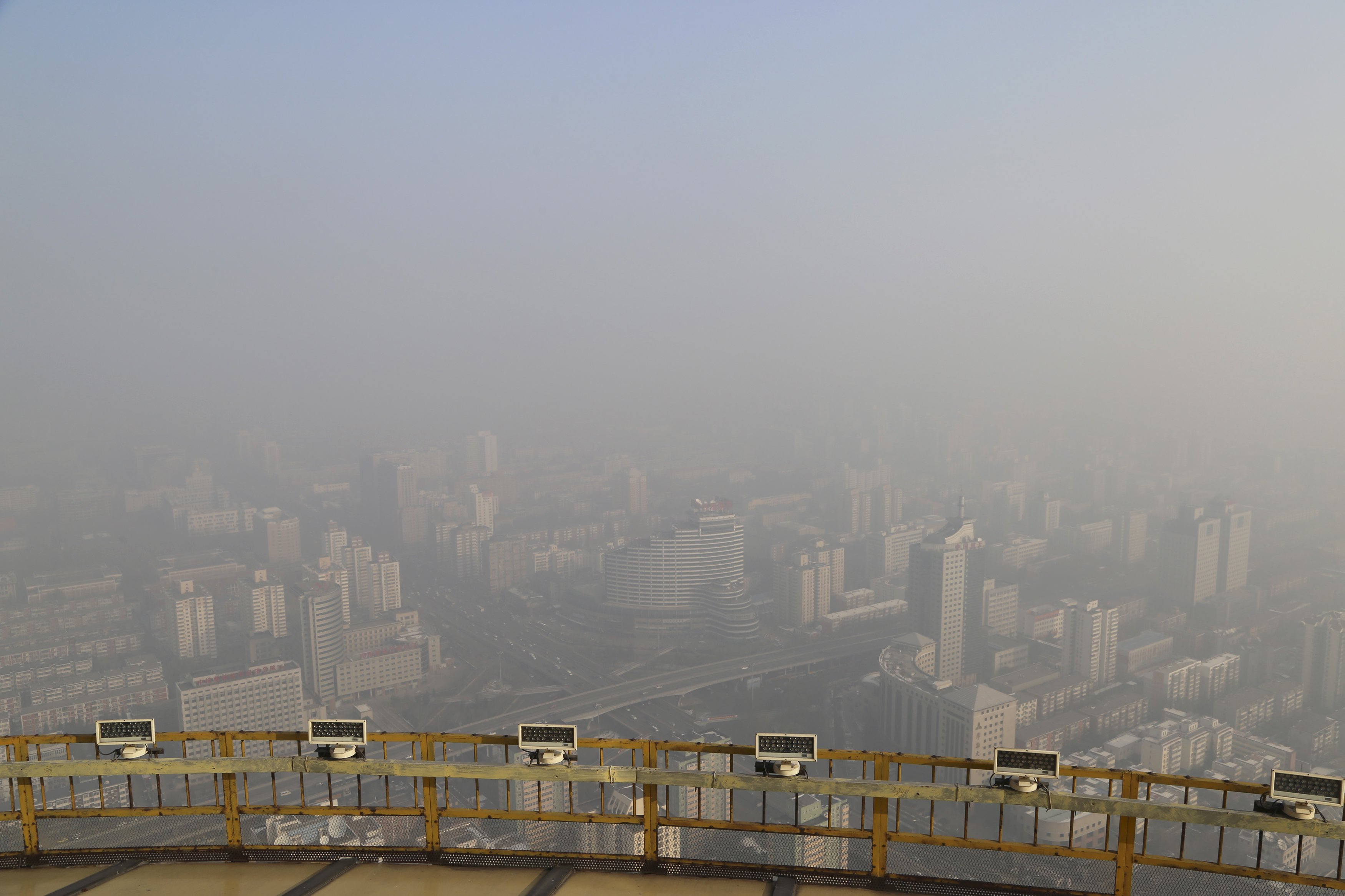 A view from a viewing deck on the China Central Radio and Television Tower shows the city of Beijing in heavy smog, China, November 29, 2015. Heavy smog continues in Beijing on Sunday after a yellow alert of air pollution was issued on Friday, local media reported. Beijing plans to ramp up its already tough car emission standards by 2017 in a bid by one of the world's most polluted cities to improve its often hazardous air quality. REUTERS/Stringer CHINA OUT. NO COMMERCIAL OR EDITORIAL SALES IN CHINA
