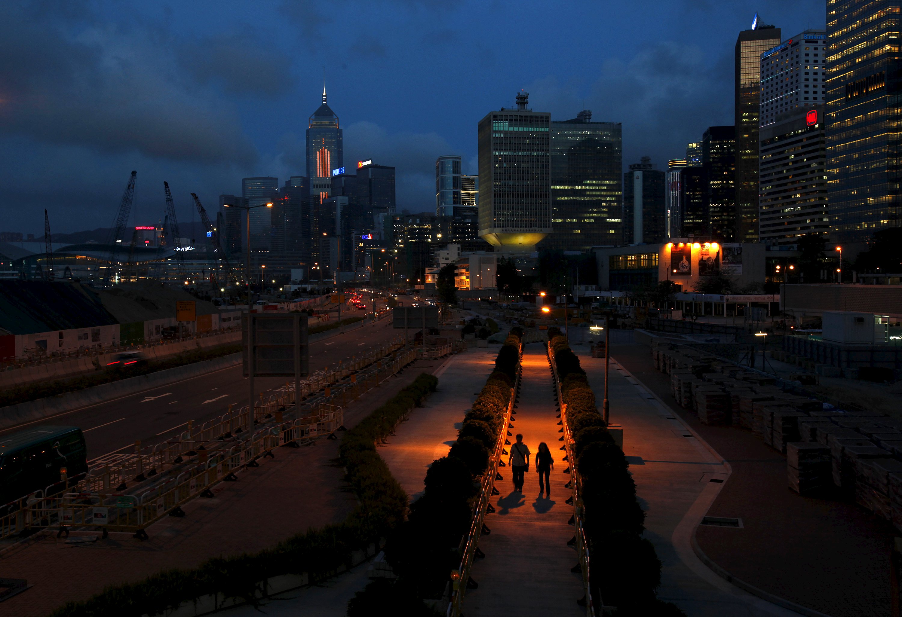 People walk on a pavement at Hong Kong's financial Central district during sunset in this May 11, 2011 file photo. Hong Kong is expected to release PMI data this week. REUTERS/Bobby Yip/Files GLOBAL BUSINESS WEEK AHEAD PACKAGE - SEARCH 'BUSINESS WEEK AHEAD NOVEMBER 30' FOR ALL IMAGES