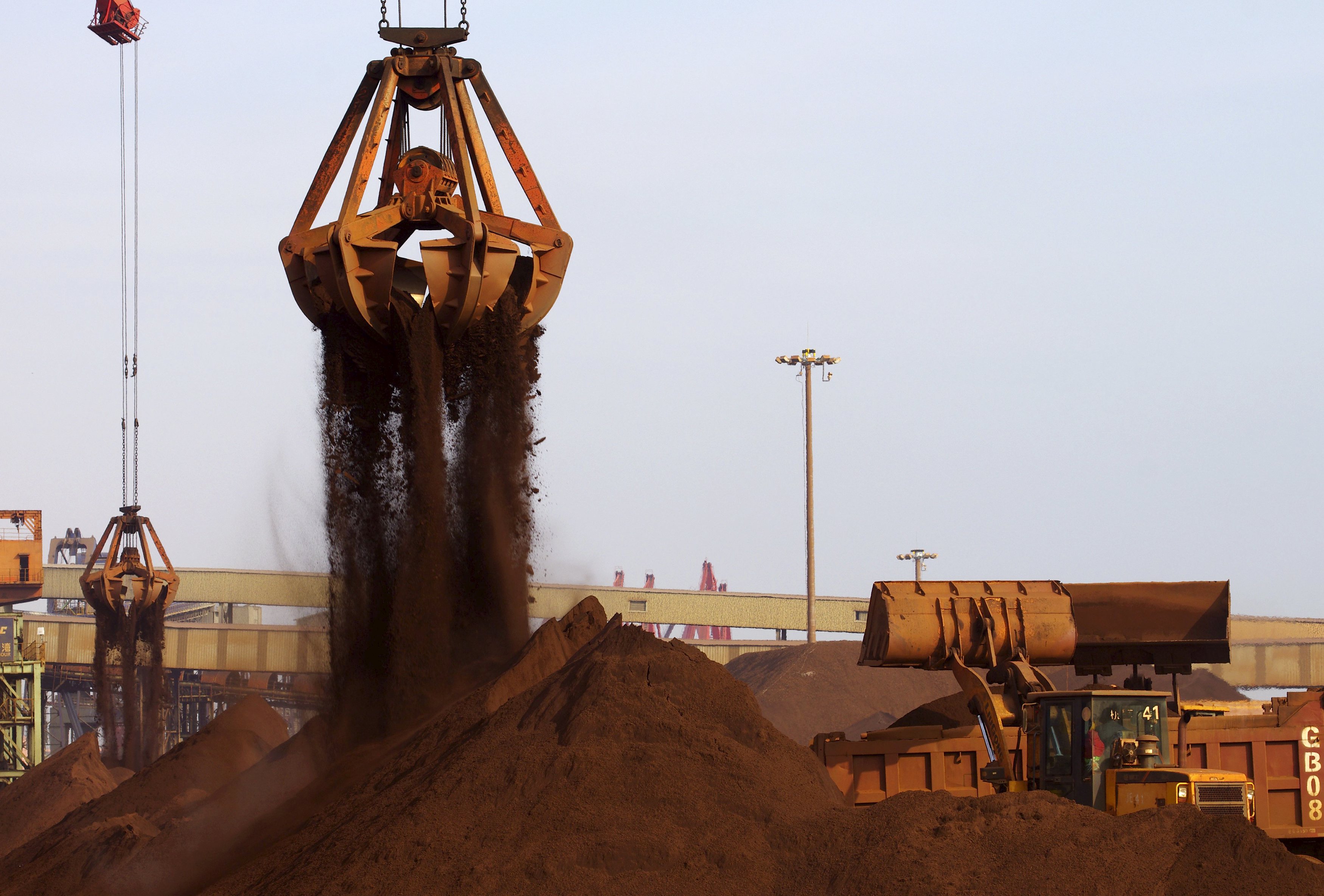 Cranes unload imported iron ore from a ship at a port in Rizhao, Shandong province, China, in this December 6, 2015 file photo. China said on December 9, 2015 it would cut some import and export taxes next year to boost its ailing trade sector, raising concerns that cheaper Chinese products could exacerbate a global oversupply of basic materials such as steel and chemicals. REUTERS/Stringer/Files CHINA OUT. NO COMMERCIAL OR EDITORIAL SALES IN CHINA