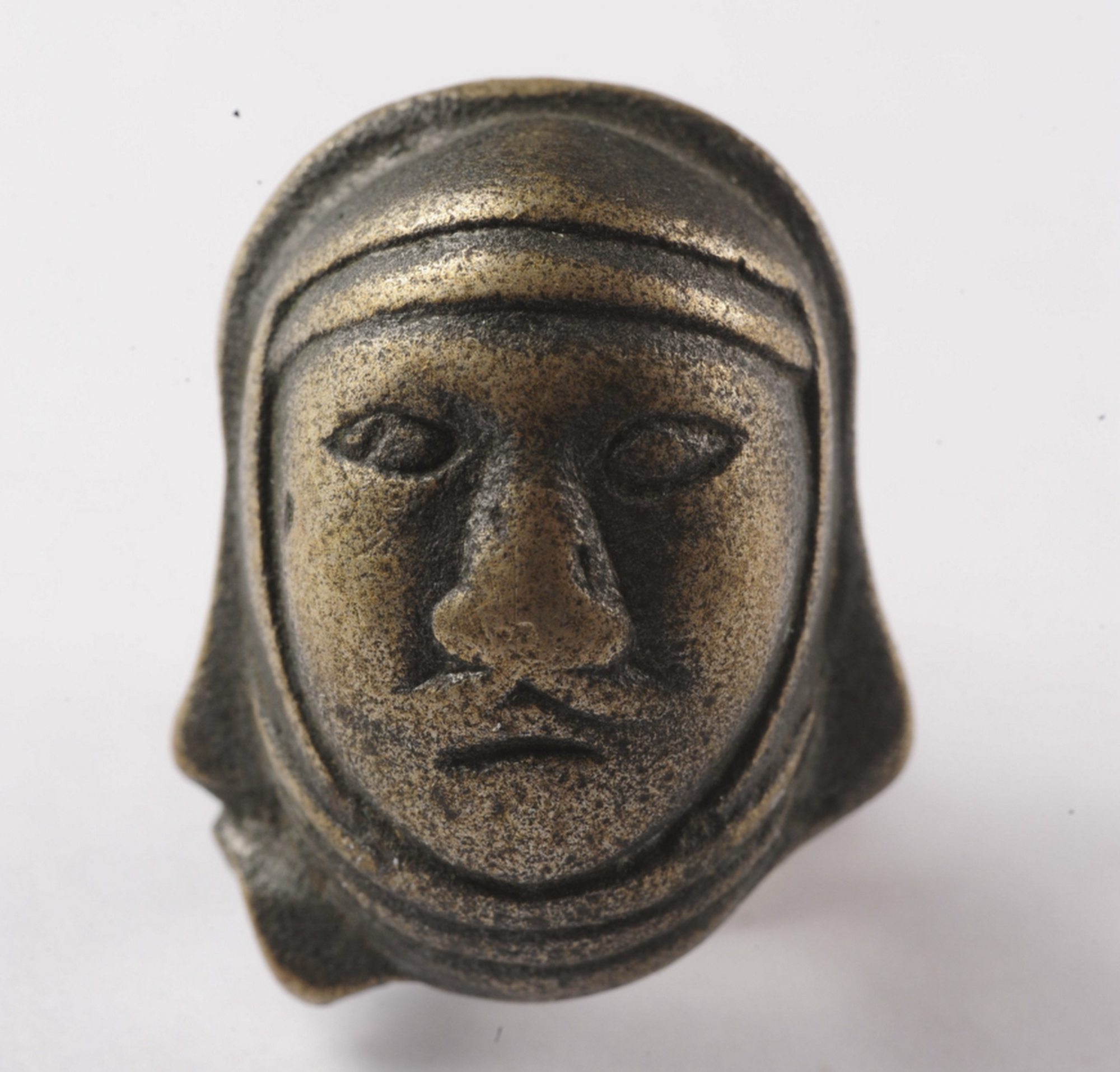 This handout image shows a object from "The Great Wall in 50 Objects," a bronze belt ornament depicting the face of a Xiongnu warrior. Photo / Courtesy of William Lindesay [03JANUARY2016 THE REVIEW BOOKS]