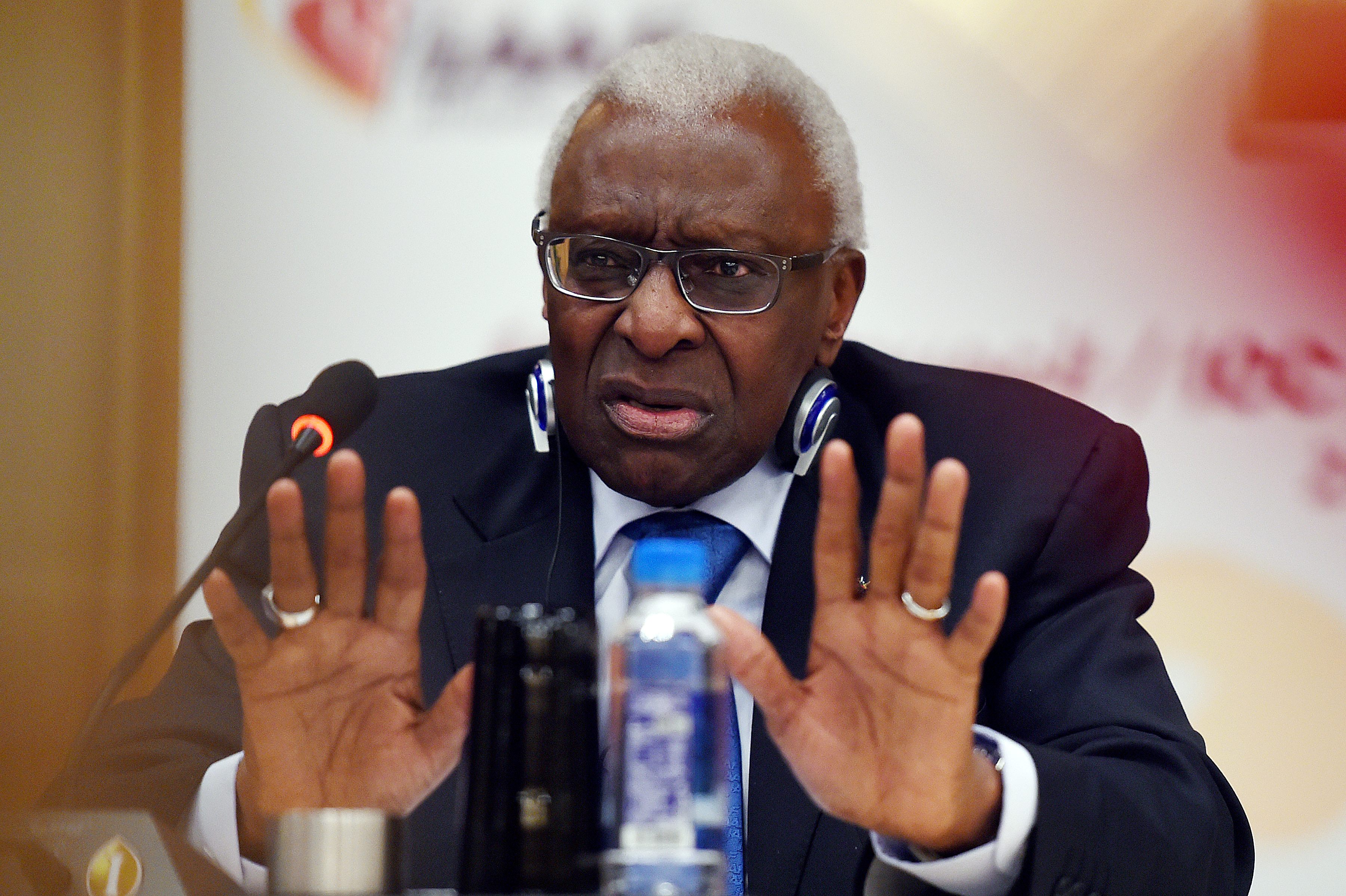 (FILES) This file photo taken on August 21, 2015 shows outgoing International Association of Athletics Federations (IAAF) president Lamine Diack gesturing during a press conference in Beijing, ahead of the 2015 IAAF World Championships. French investigators on December 21, 2015 hit former IAAF president Lamine Diack with new corruption charges linked to doping cover-ups in world athletics, a source close to the inquiry told AFP. / AFP / Greg Baker