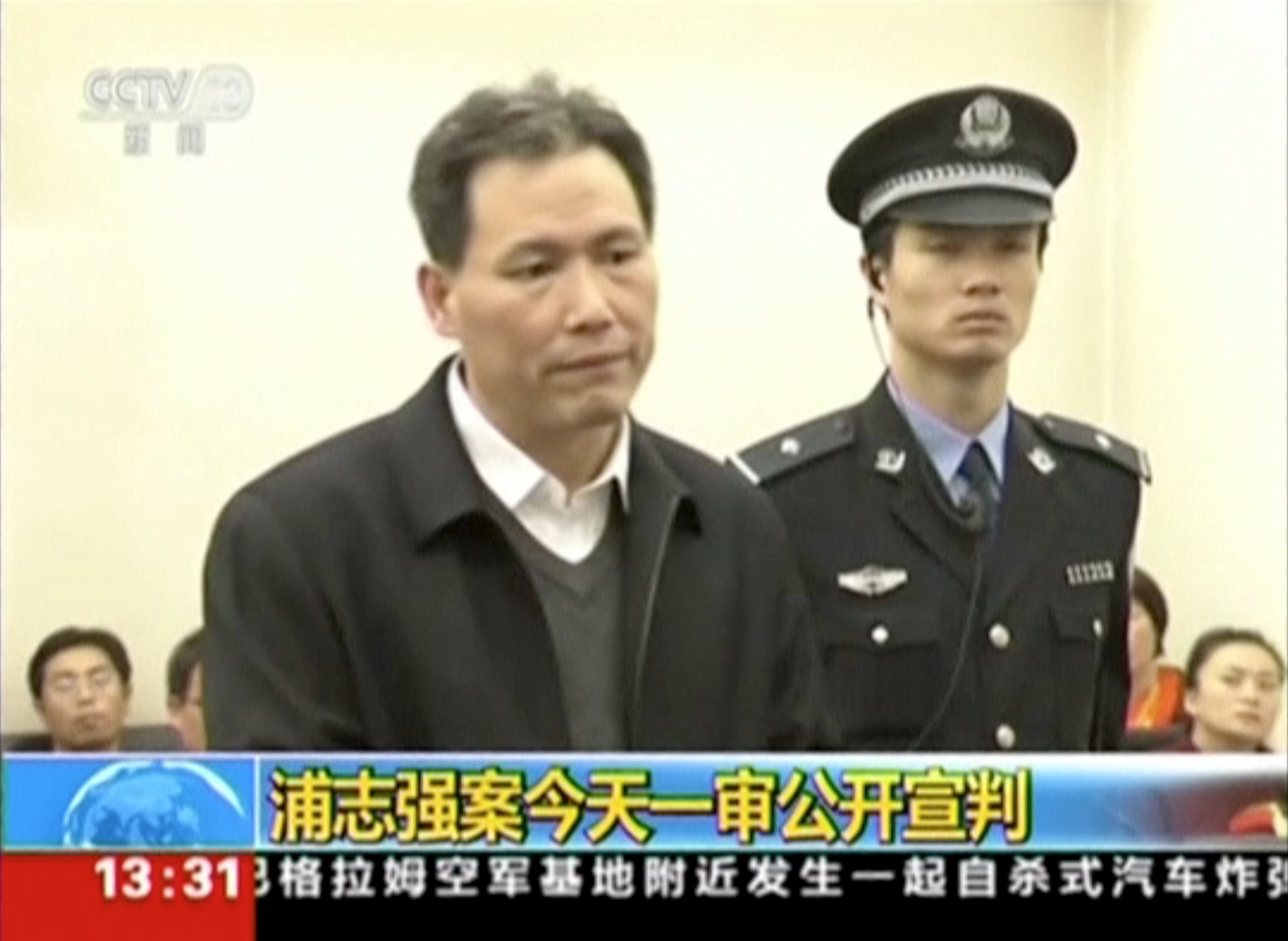 China's rights lawyer Pu Zhiqiang (L) speaks at a court session in Beijing in this still image from a December 14, 2015 video. The court convicted Pu, one of China's most prominent rights lawyers, on December 22, 2015 of "inciting ethnic hatred" and trouble-making with posts criticising the government, handing down a suspended sentence that means he avoids jail but will not practise law again. REUTERS/CCTV via Reuters TV ATTENTION EDITORS - THIS IMAGE WAS PROVIDED BY A THIRD PARTY. THIS PICTURE IS DISTRIBUTED EXACTLY AS RECEIVED BY REUTERS, AS A SERVICE TO CLIENTS. CHINA OUT. NO COMMERCIAL OR EDITORIAL SALES IN CHINA. TPX IMAGES OF THE DAY