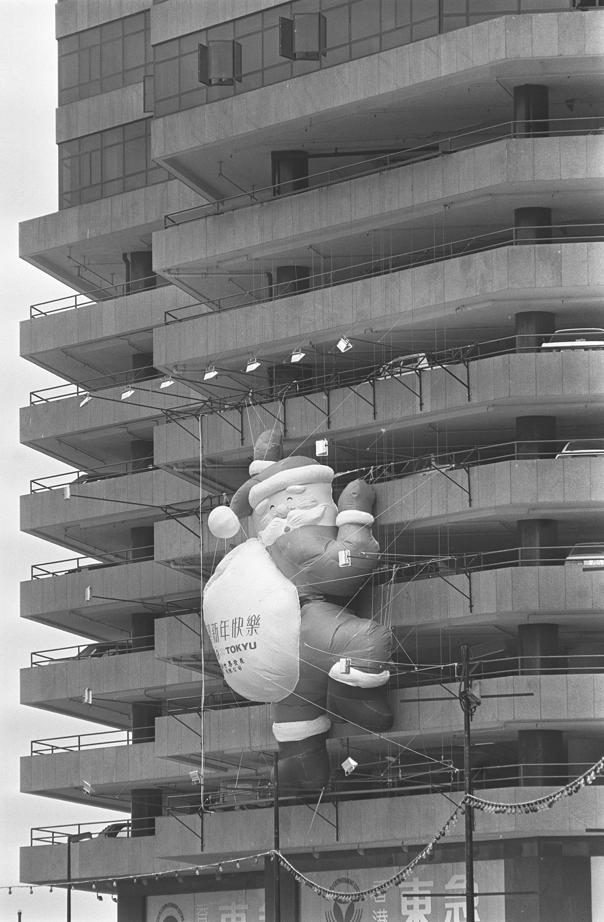 This gigantic Santa Claus is clearly going to have trouble going down the air-conditioning shaft of the New World Centre.