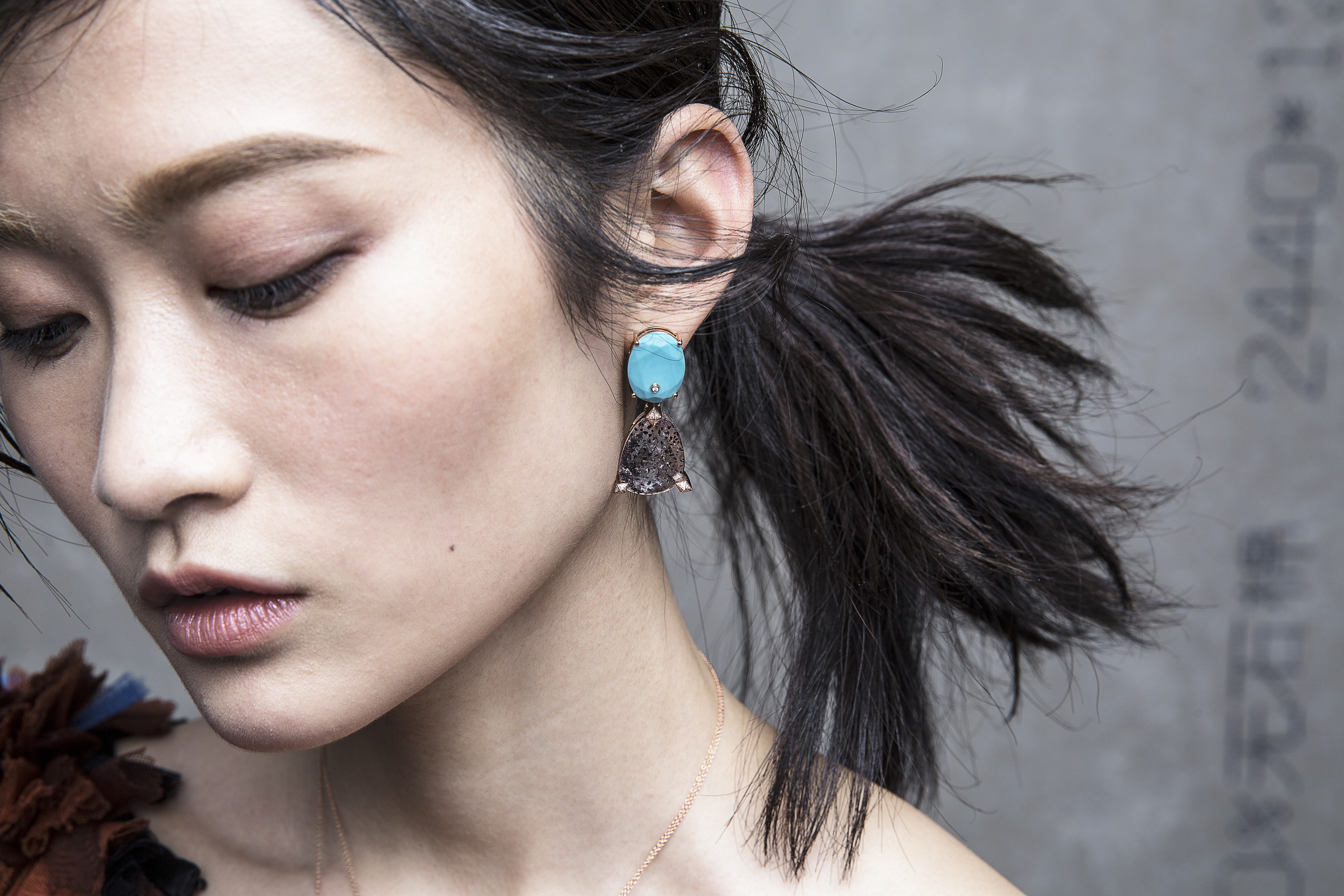 This handout image shows a models presents Turquoise, diamond, rutilated topas and smokey quartz earrings in 18K rose gold, by Lama Hourani. Photo / HANDOUT [11JANUARY2016 FEATURES LIFE FASHION]
