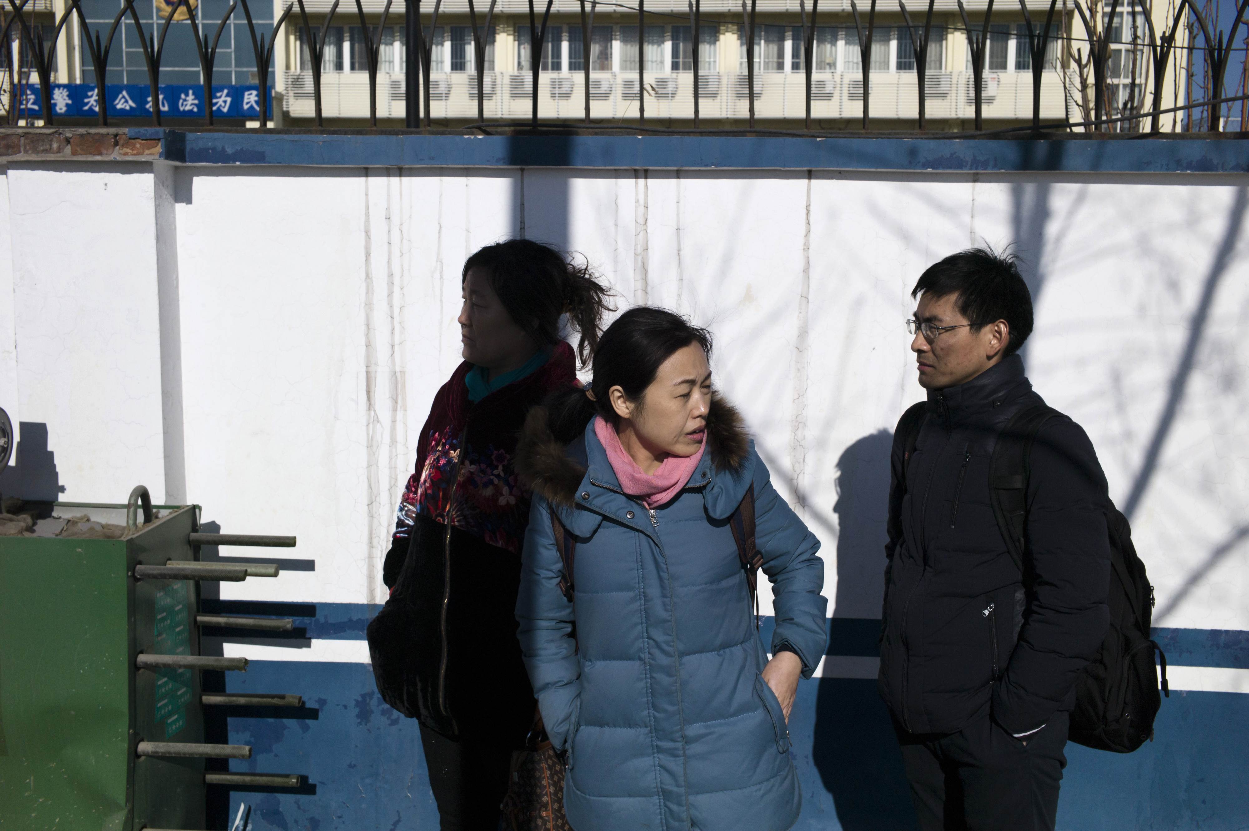 Family members and lawyers of detained lawyers and their colleagues gather after another attempt to seek answers at the Hexi District Detention Centre in Tianjin on January 8, 2016. Six months ago, China's biggest-ever crackdown on human rights lawyers saw state agents question more than 130 attorneys and their colleagues. AFP PHOTO / FRED DUFOUR