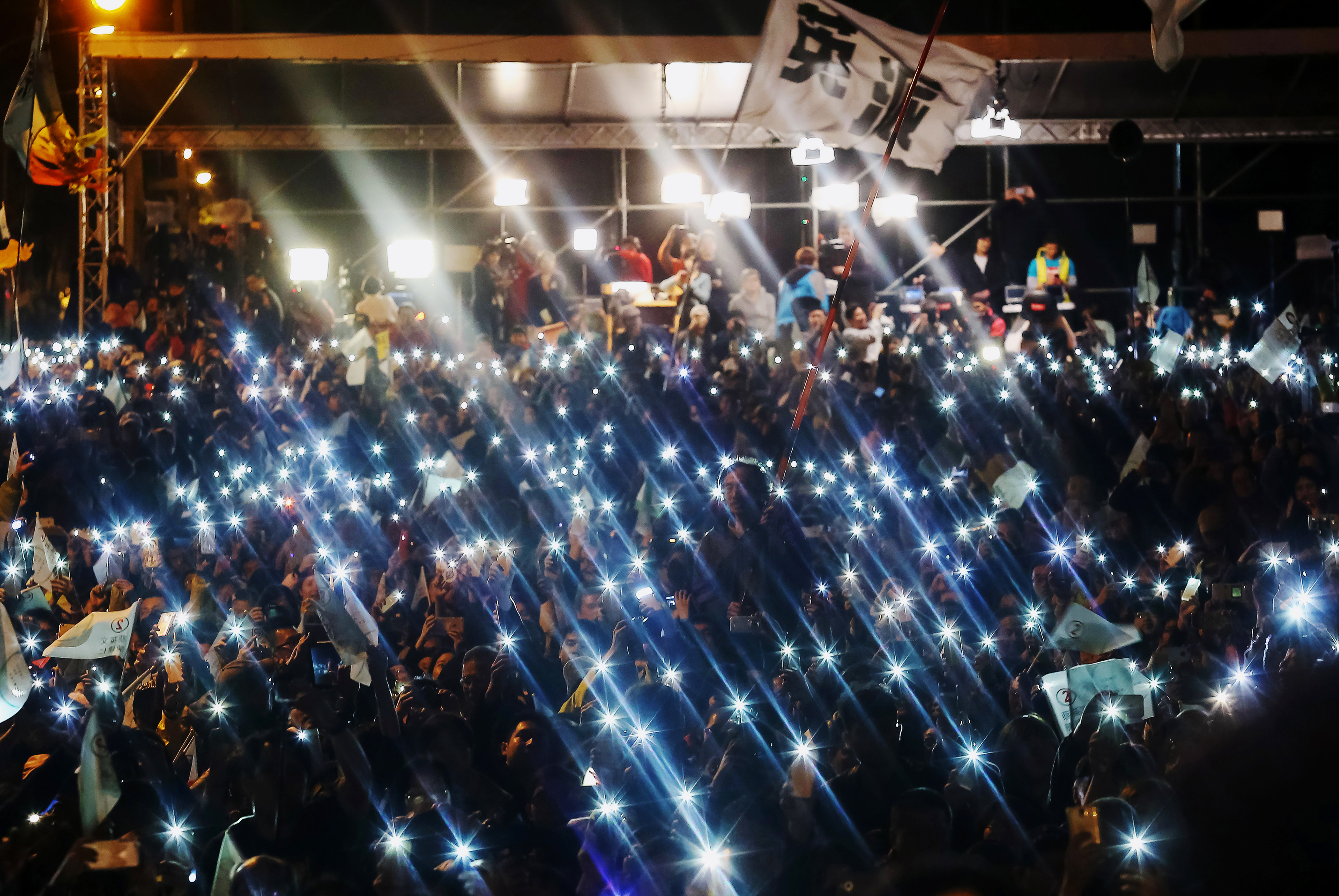 Democratic Progressive Party (DPP) supporters shine lights from their mobile devices as they celebrate election results during a rally in Taipei, Taiwan, on Saturday, Jan. 16, 2016. Taiwan opposition leader Tsai Ing-wen rode a tide of discontent over everything from China ties to economic growth to become the islands first female president and secure a historic legislative majority for her Democratic Progressive Party. Photographer: Maurice Tsai/Bloomberg ORG XMIT: 600236675