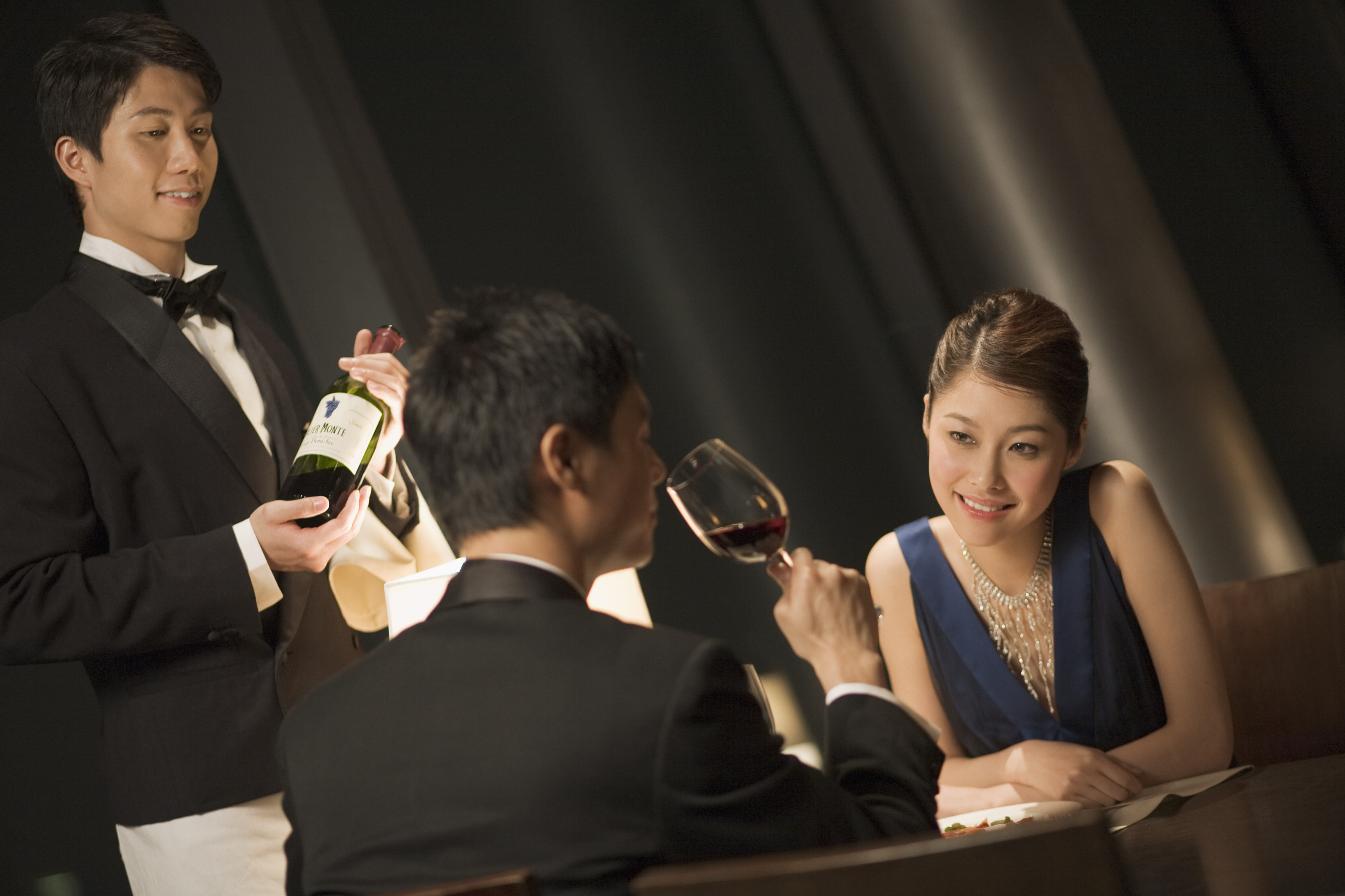 Chinese couple in restaurant tasting wine --- Image by © Ken Seet/Corbis [22JANUARY2016 FEATURES WINE]