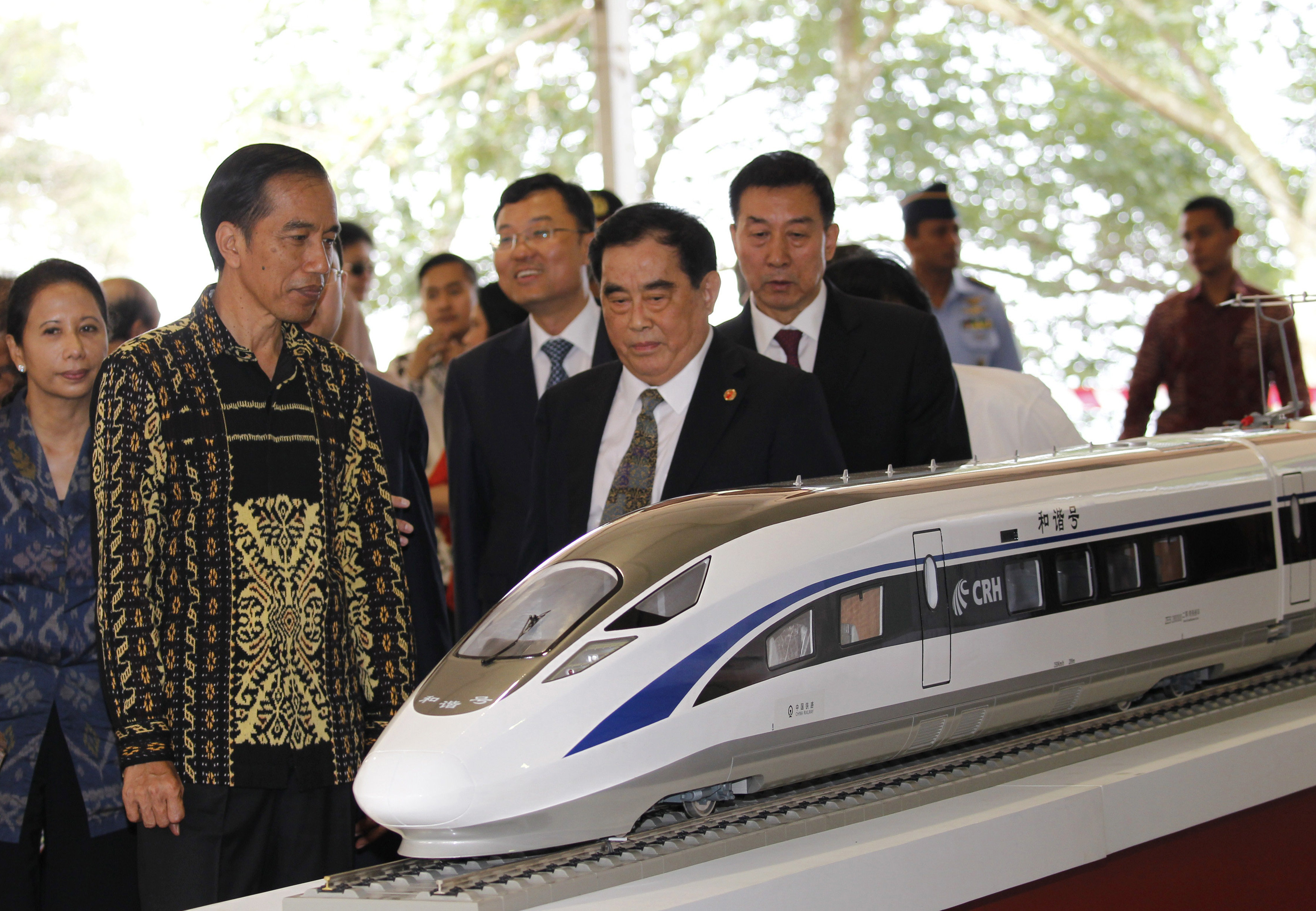 Indonesian President Joko Widodo (2nd L) and the general manager of China Railway Corp. Sheng Guangzu (C) stand next to a model of a train while attending a ground breaking ceremony for the Jakarta-Bandung fast-train railway line in Walini, West Java province, Indonesia January 21, 2016. REUTERS/Garry Lotulung FOR EDITORIAL USE ONLY. NO RESALES. NO ARCHIVES.