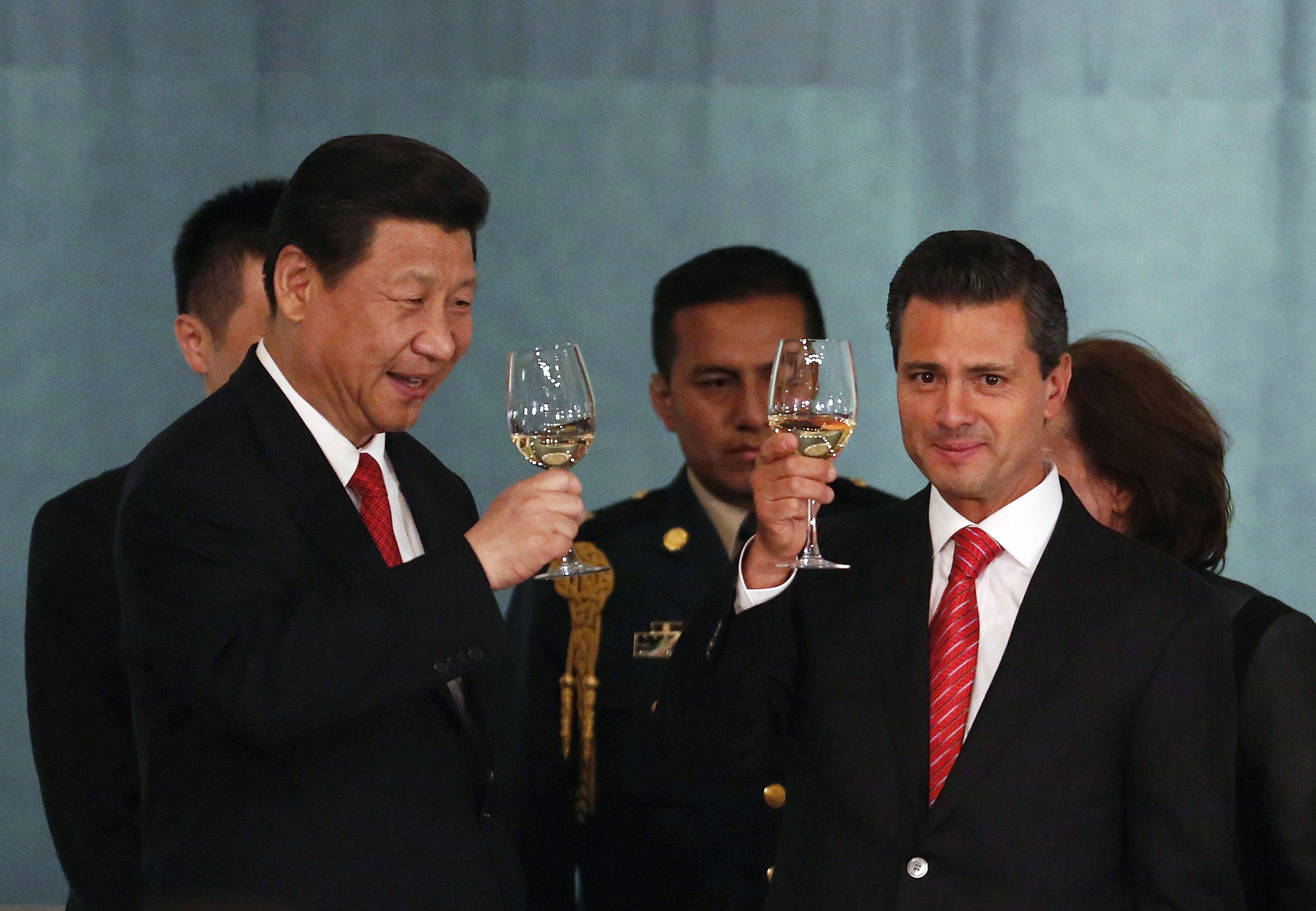 Mexico's President Enrique Pena Nieto (R) and China's President Xi Jinping make a toast during a dinner at the National Palace in Mexico City in this June 4, 2013 file photo. When the leaders of Mexico and China met this summer, there was much talk of the need to deepen trade between their nations. Down on the Pacific shores of Mexico, a drug gang was already making it a reality. The Knights Templar cartel was so successful at exporting iron ore to China that the Navy last month took over the port in a city that has become one of the gang's principal cash cows: Lazaro Cardenas in the western state of Michoacan. To match Feature MEXICO-DRUGS/PORT REUTERS/Tomas Bravo/Files (MEXICO - Tags: CRIME LAW POLITICS DRUGS SOCIETY BUSINESS)