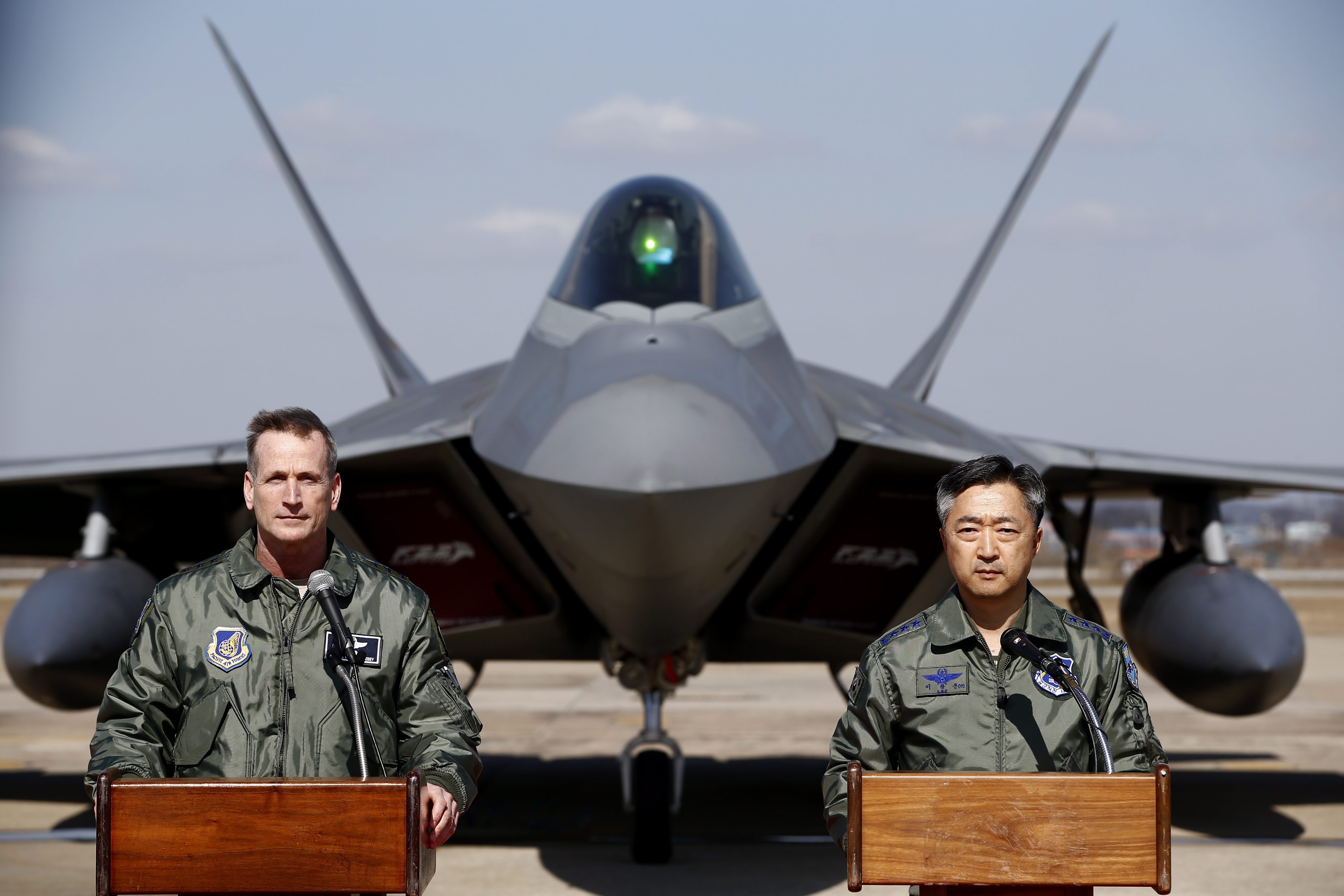 US Lieutenant General Terrence O’Shaughnessy, deputy commander of the US Forces Korea, and Lee Wang-geun, commander at South Korea’s Air Force Operations, speak in front of a F-22 stealth fighter during a press briefing in South Korea. Photo: EPA