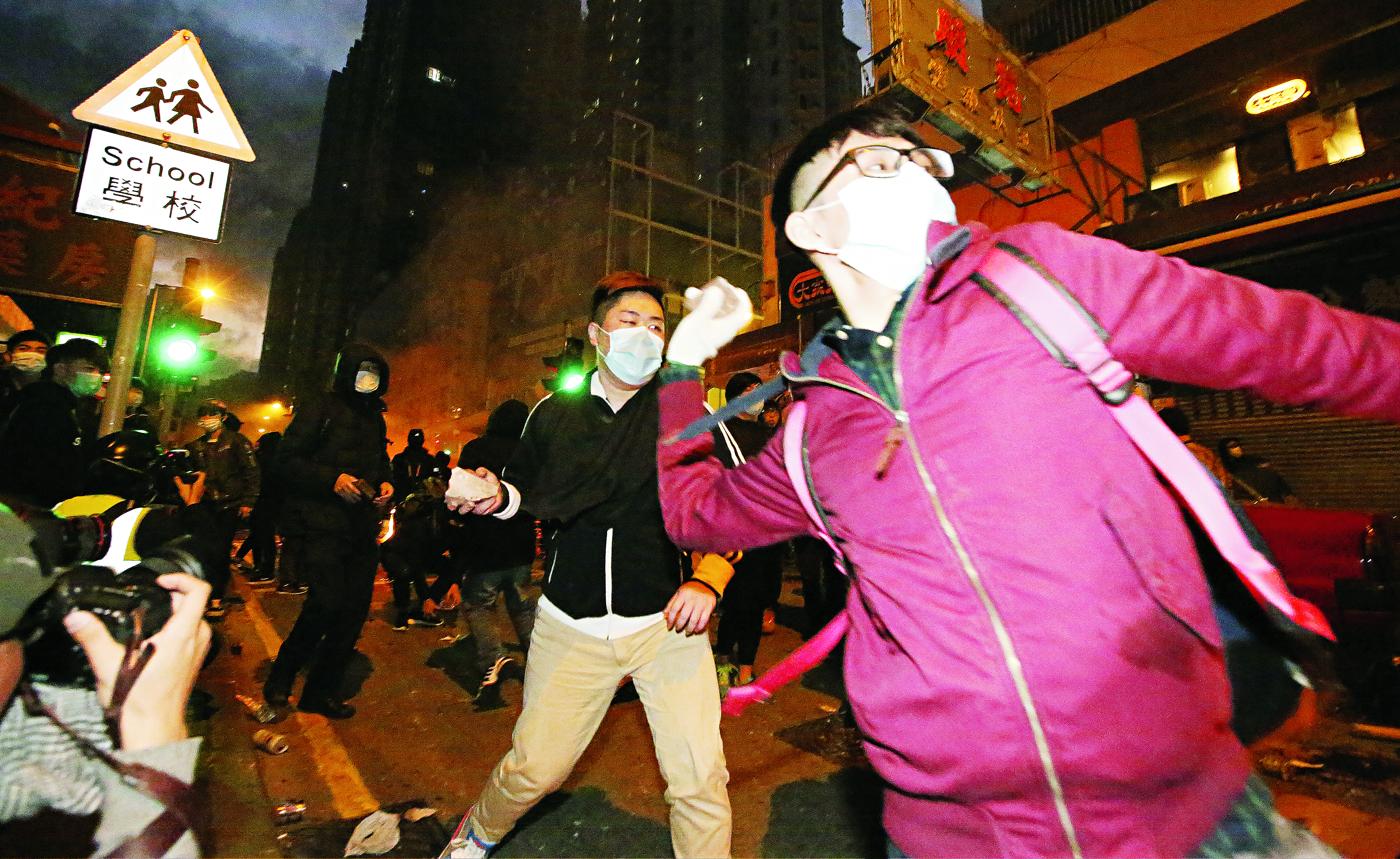 Rioters throw bricks in Mong Kok during the recent protest. Photo: Edward Wong