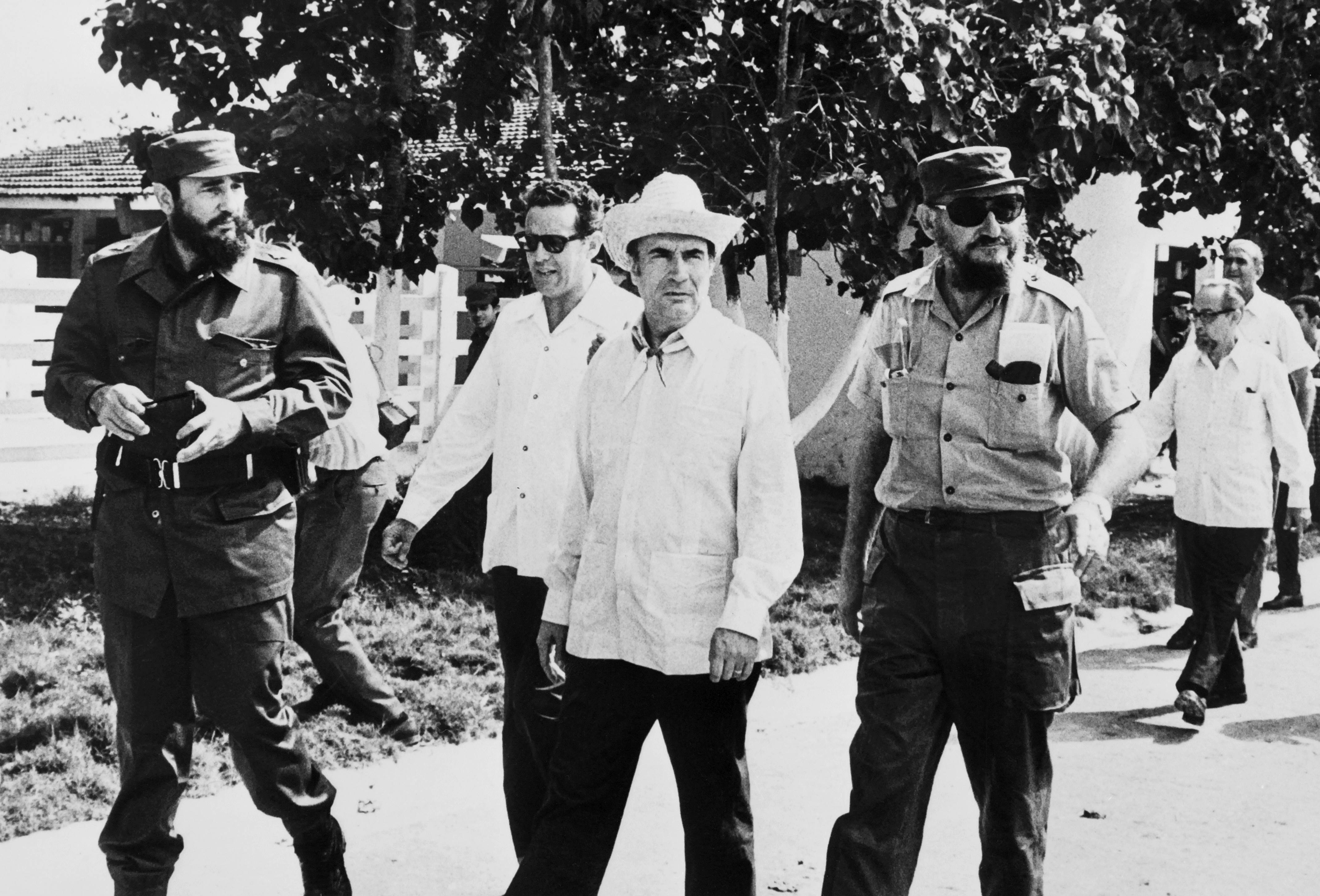 Fidel Castro (left), Ramon Castro (right) and future French president François Mitterrand (centre) stroll through Havana on December 14, 1974. Photo: AFP