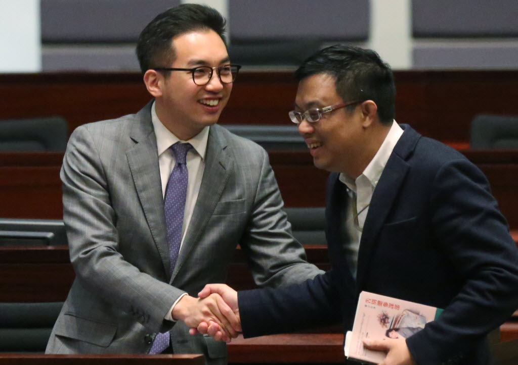 Newly elected Legislative Council member Alvin Yeung Ngok-Kiu shake hands with Legislative Council member James To Kun-sun before a swearing-in ceremony at Legco Chamber in Tamar. Photo: SCMP