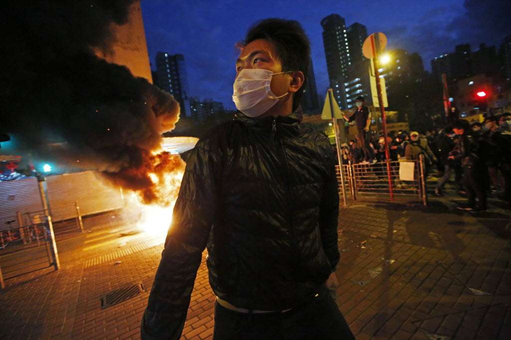 Smoke rises as rioters start fires on a street in Mong Kok district of Hong Kong on February 9 this year. Photo: AP