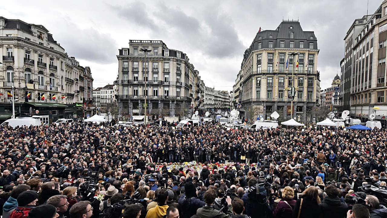 People observe a minute of silence at the Place de la Bourse in Brussels. Photo: AP