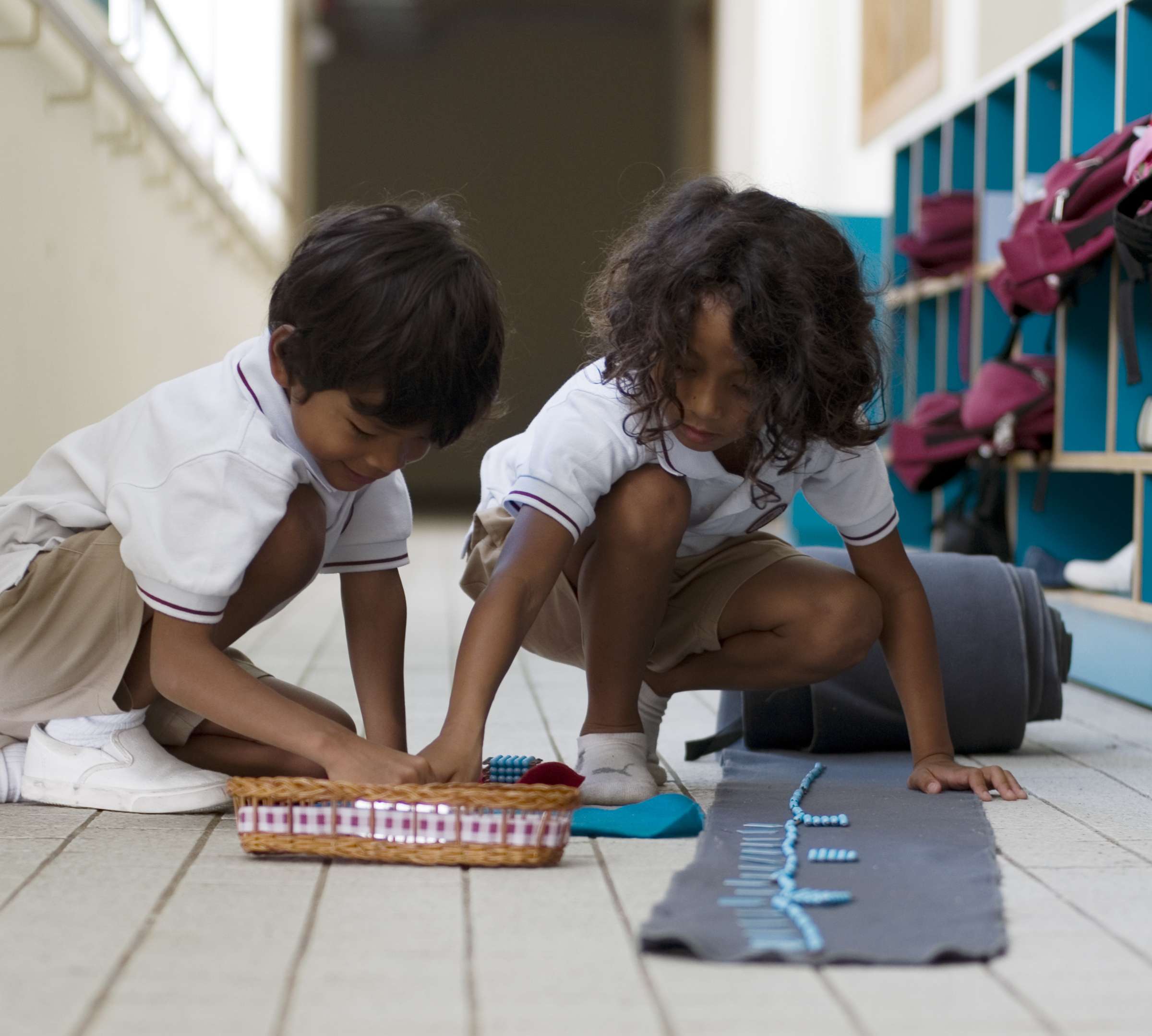 Montessori pupils learn maths in the corridor.