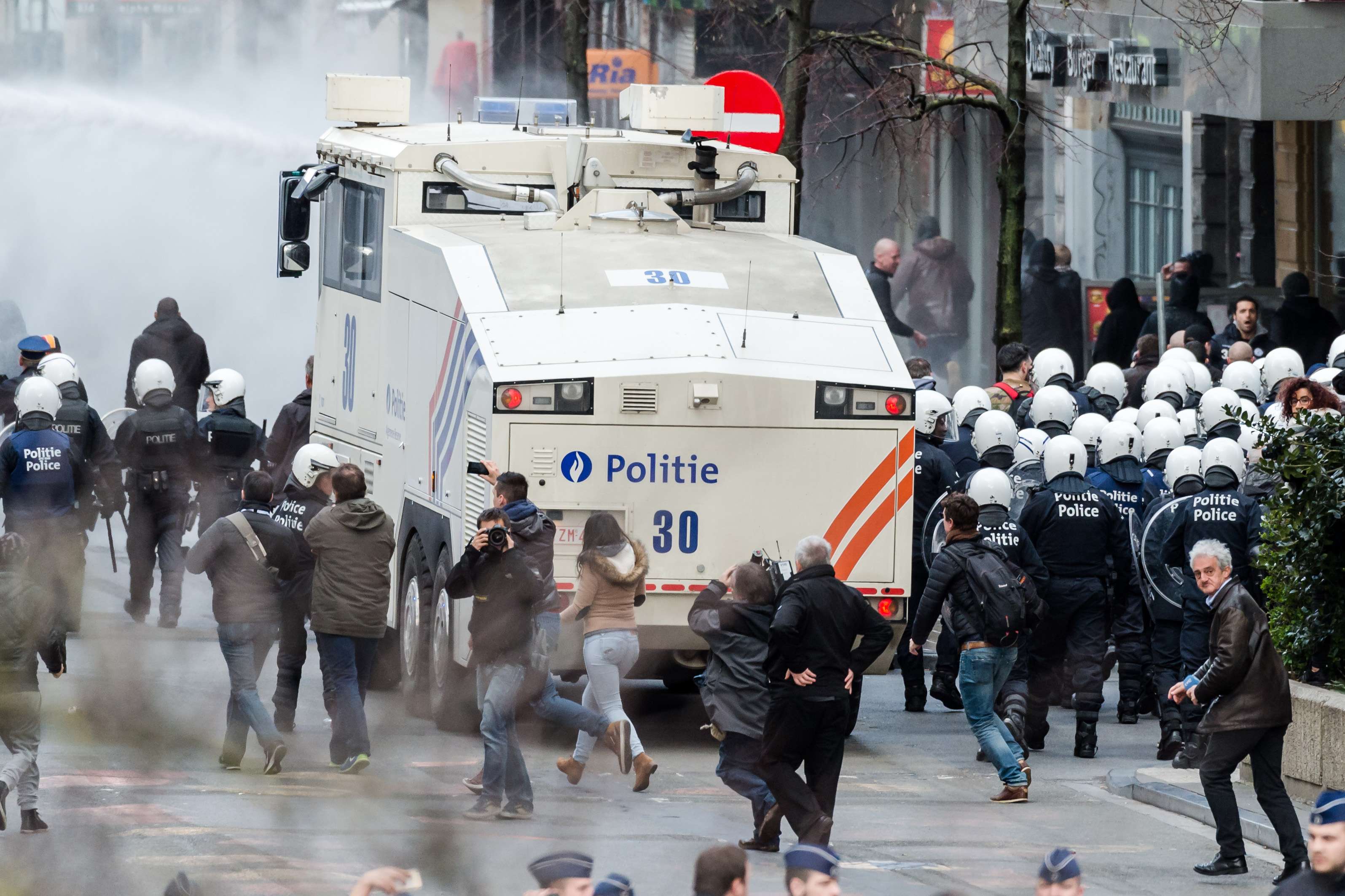 Police use a water cannon as far-right demonstrators protest at a memorial in Brussels. Photo: AP