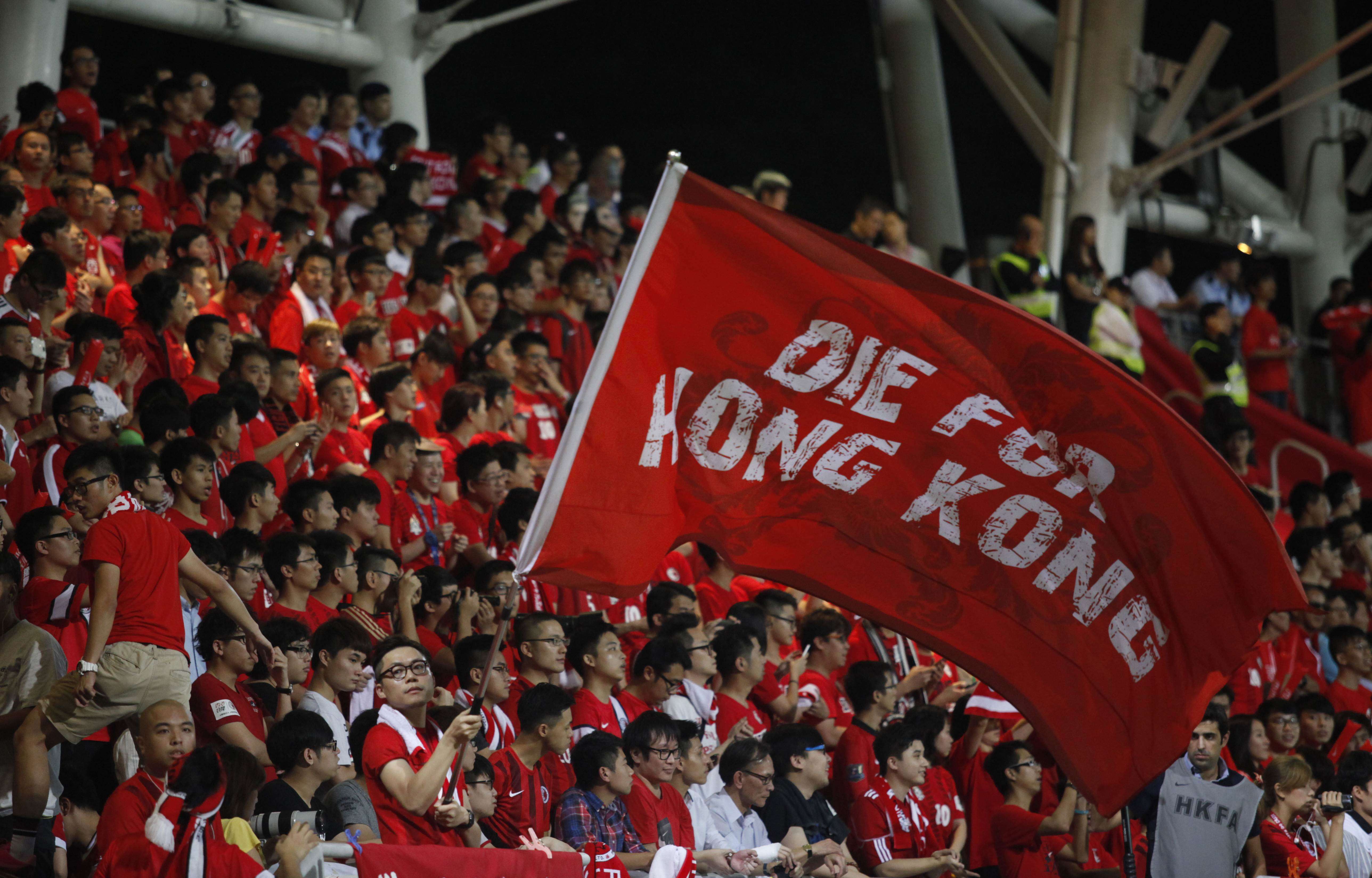 A Hong Kong football fan waves a flag during a world cup qualifier at Mong Kok Stadium last year. Hong Kong fans booed the anthem they share with China while some turned their backs in a show of defiance. Photo: AFP