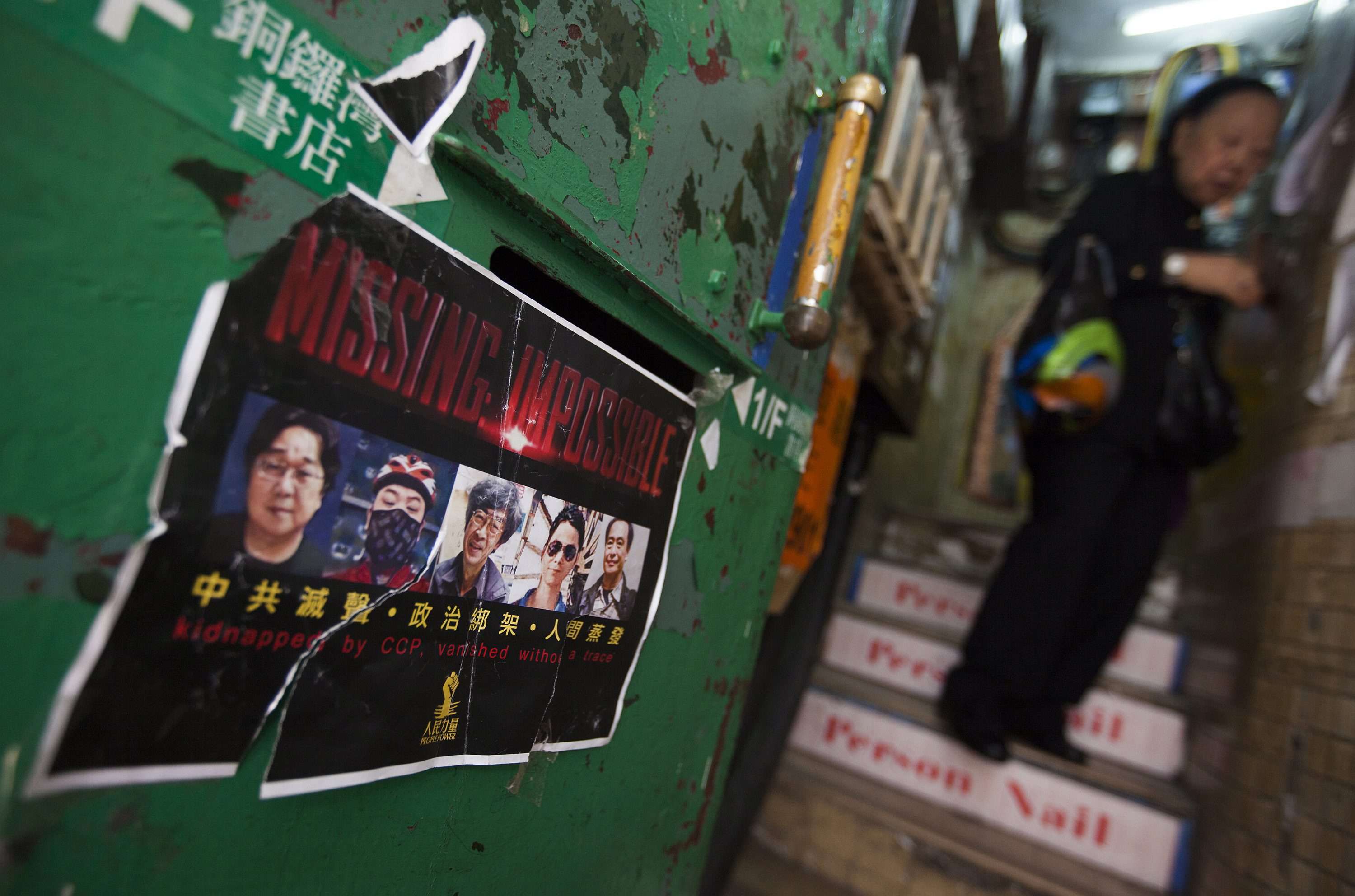 A poster supporting the missing booksellers is seen on the stairs leading up to Causeway Bay Books, just days after Lee Po, the proprietor of the shop, reappeared in Hong Kong. Photo: EPA