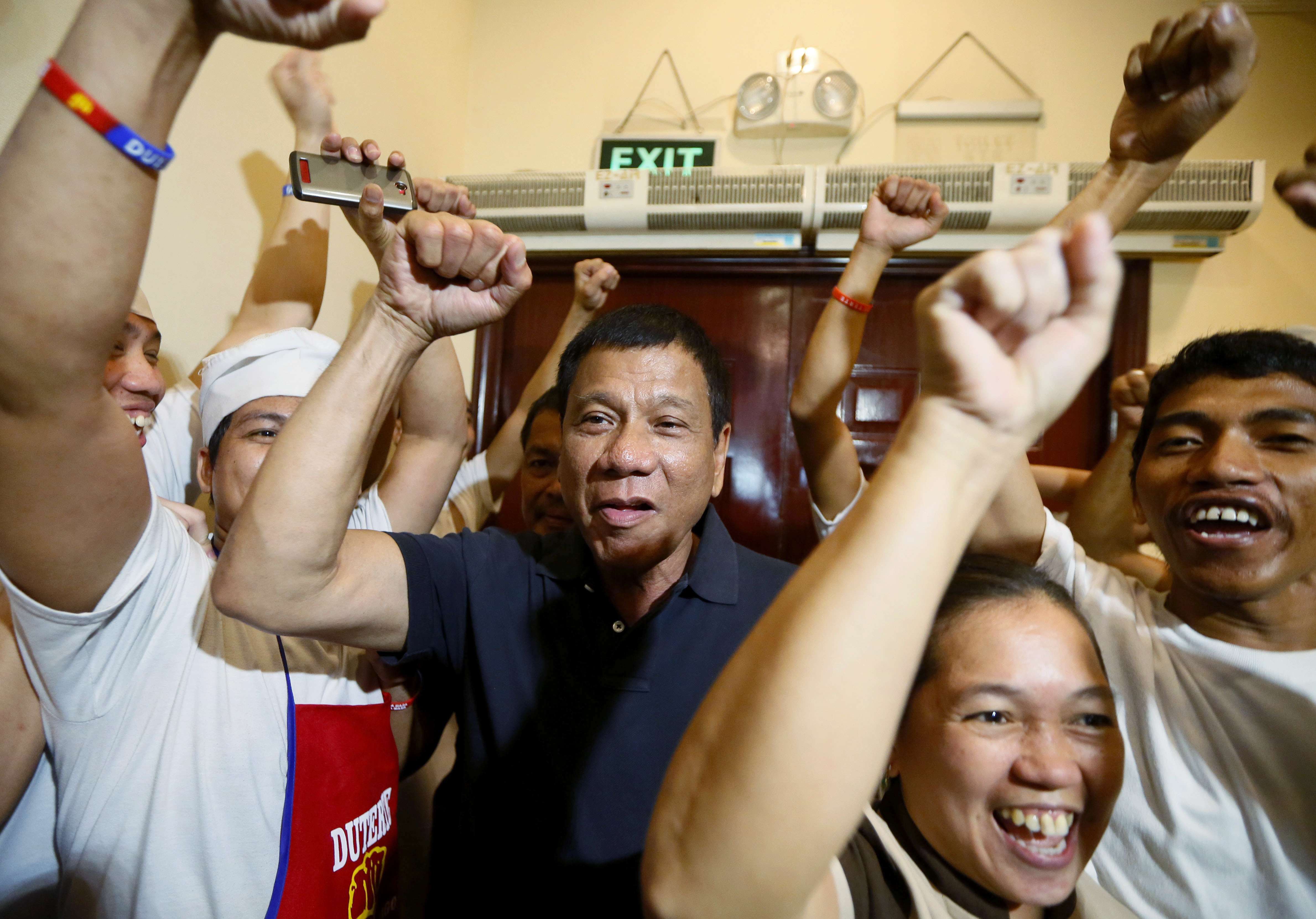 Philippine presidential candidate Rodrigo Duterte being cheered by the kitchen staff of a restaurant in Manila. Photo: AP