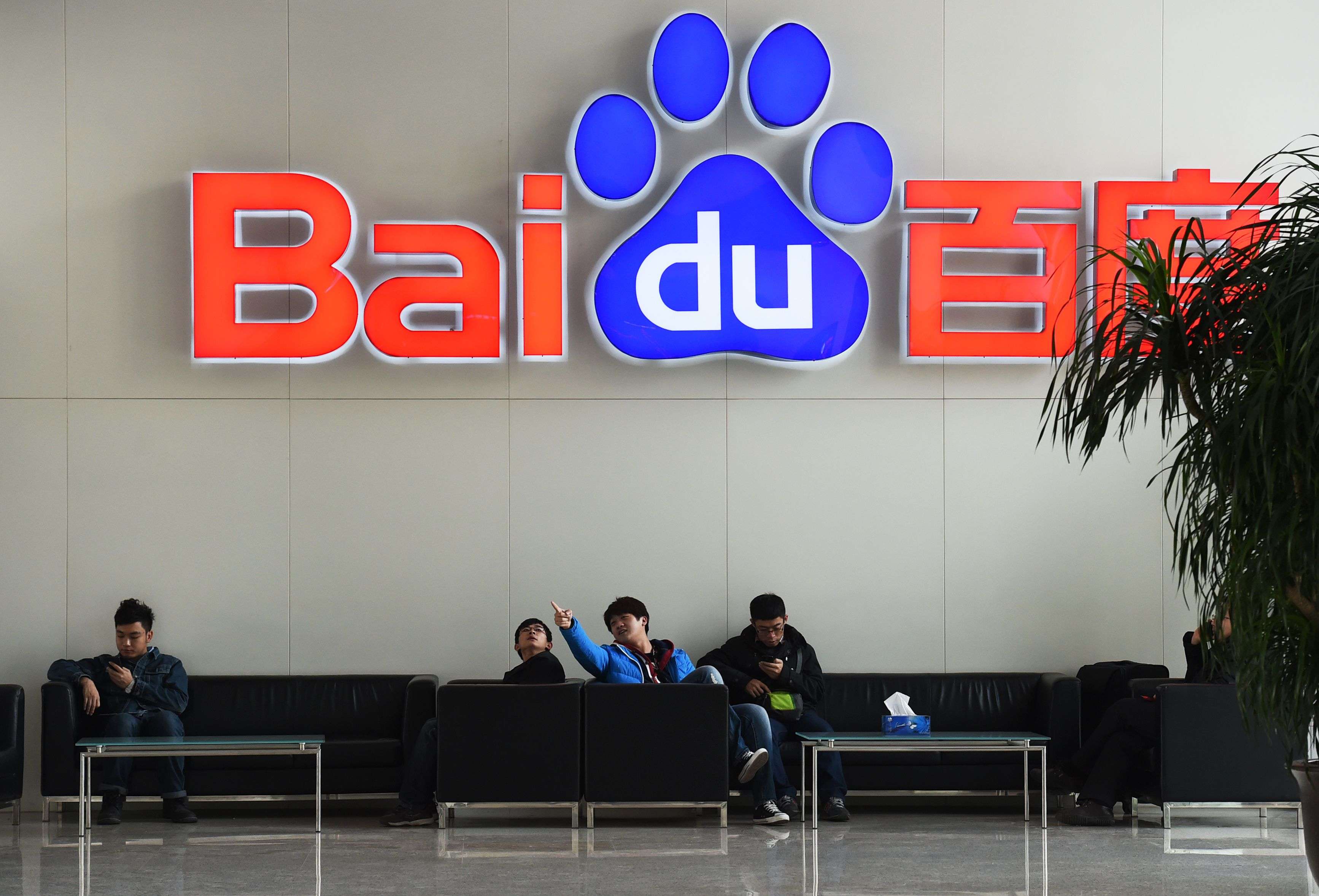 A 2014 file photos shows people sitting below a Baidu logo at the Baidu headquarters in Beijing. Photo: AFP