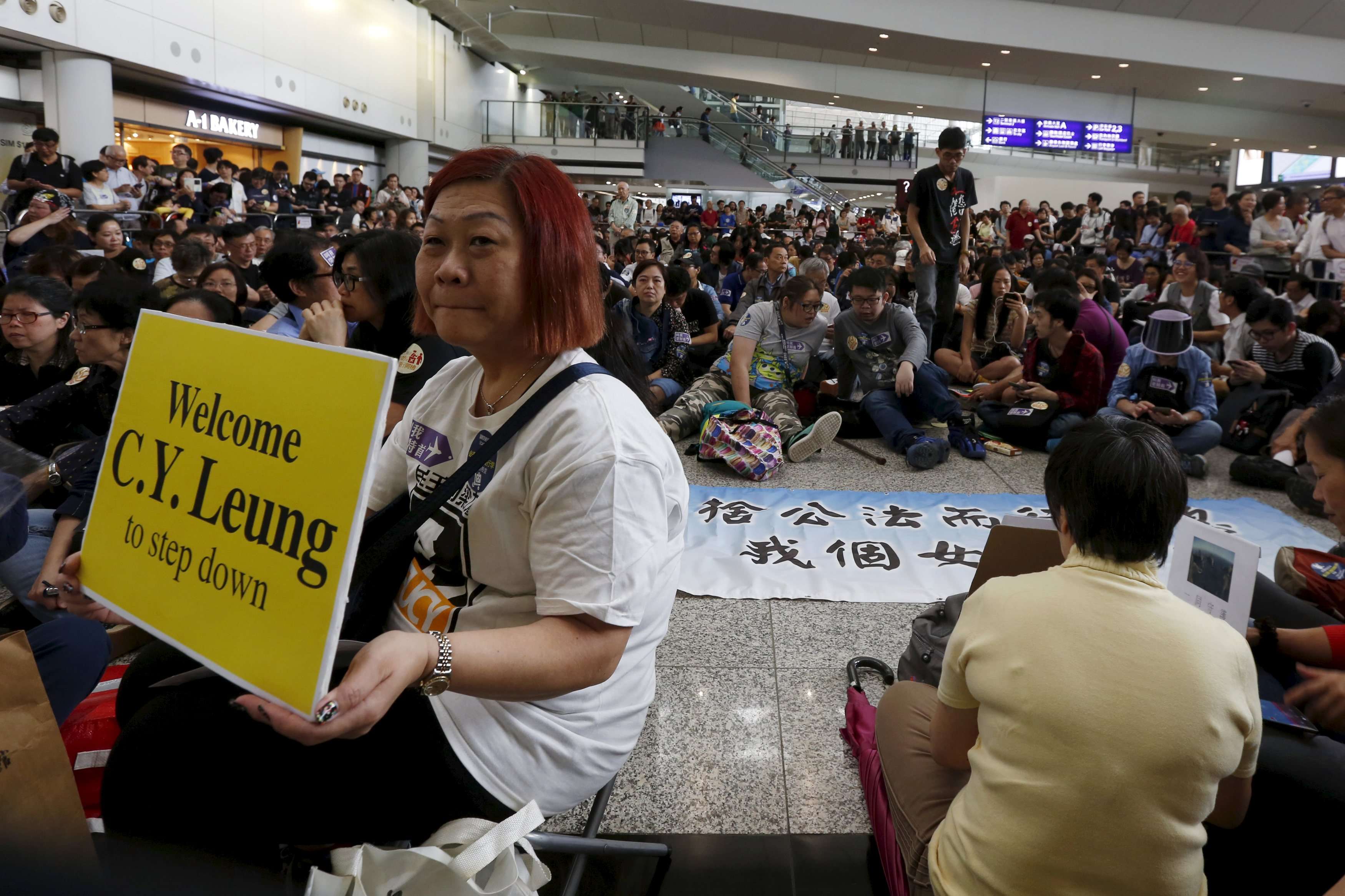 More than 1,000 people protested at the Hong Kong airport against Leung Chun-ying’s alleged abuse of power. Photo: Reuters
