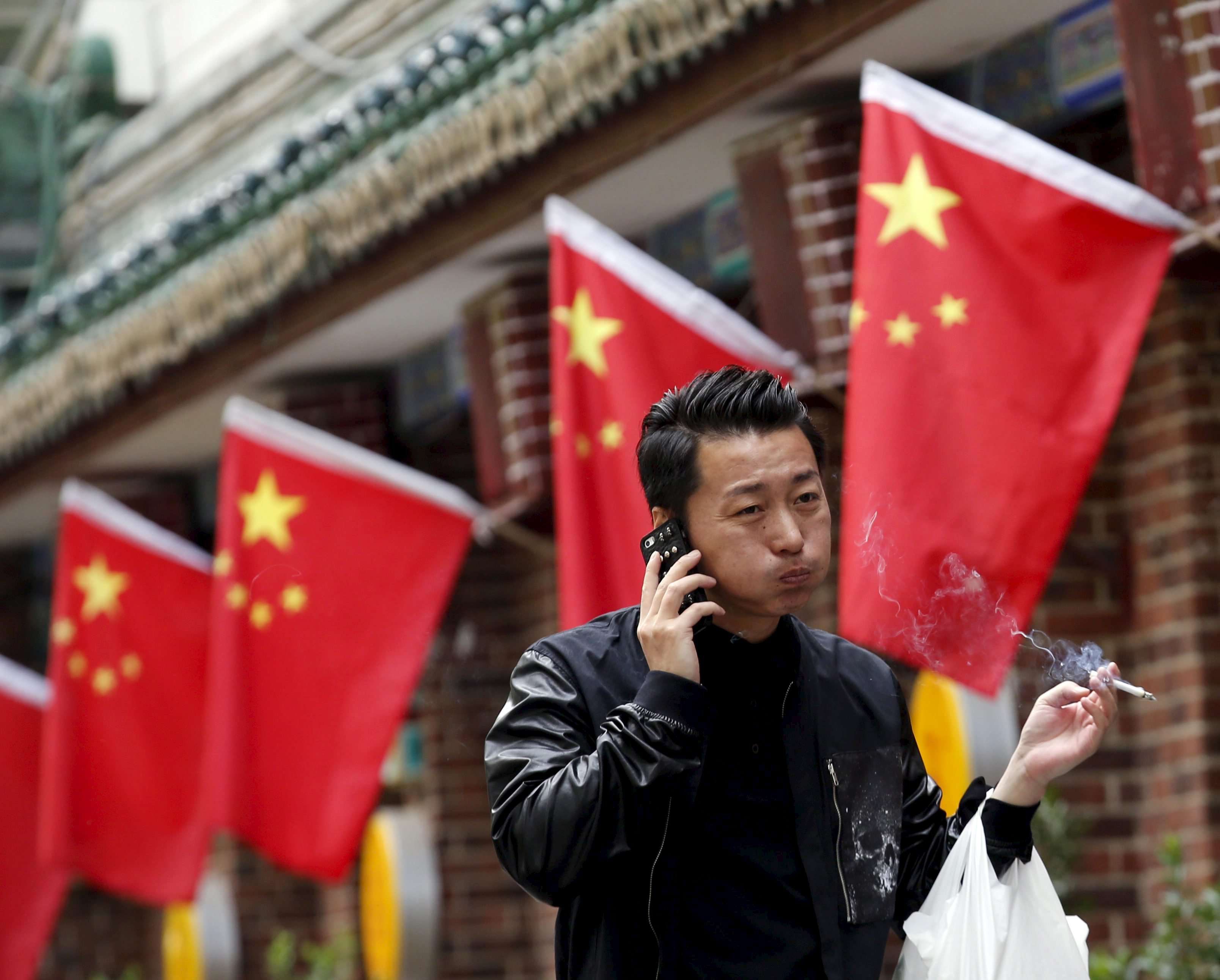 A man talks on his mobile phone in Beijing. Mainland police have intensified their efforts against telecoms scams in recent months. Photo: Reuters