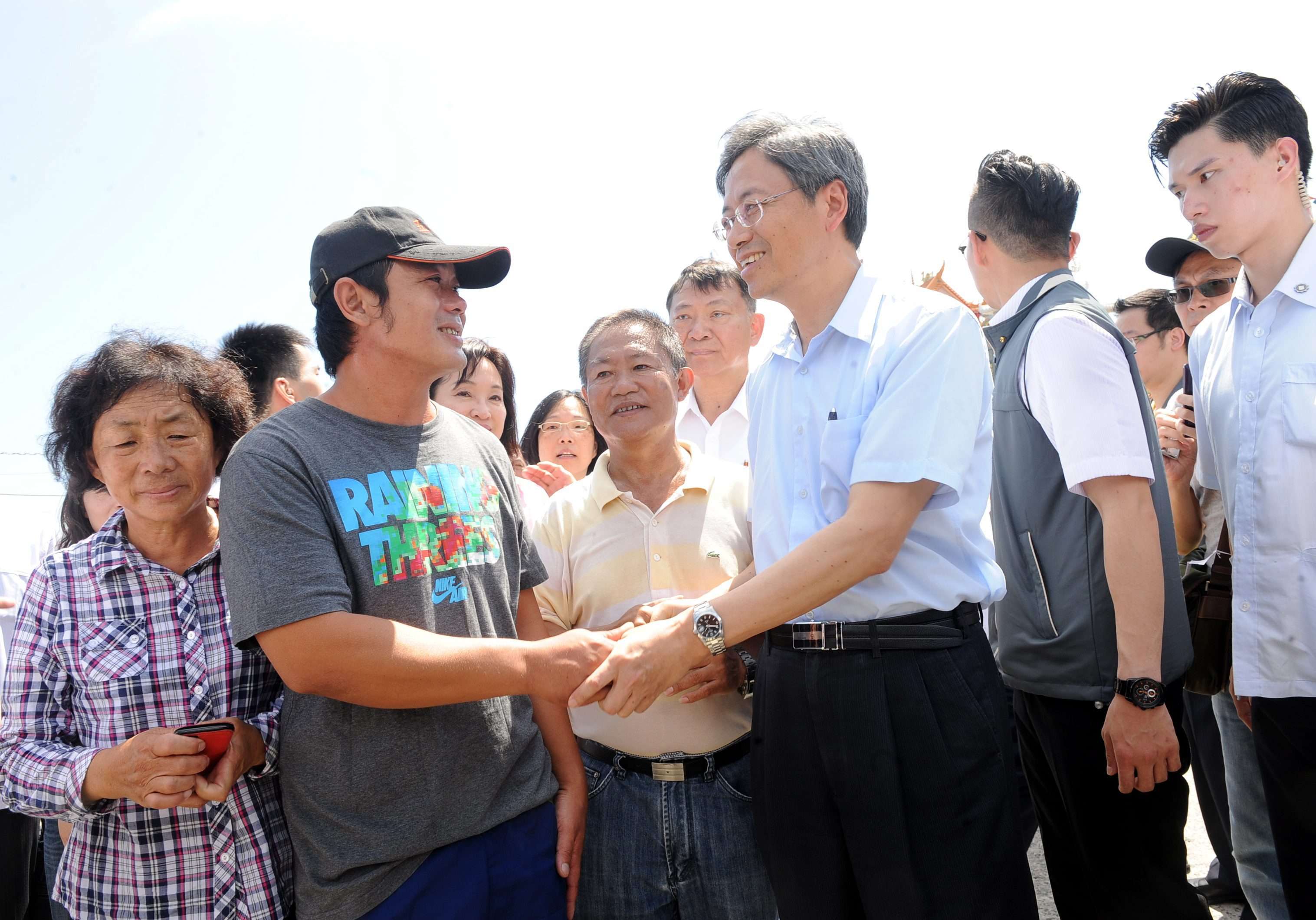 A handout photograph made available by the Taiwanese government shows Premier Chang San-cheng greeting Captain Pan Chien-peng at Hsiao Liuchiu Port in Pingtung county, following Japan's release of Pan's boat, and Pan and nine crew members, after his father paid a fine. Photo: EPA