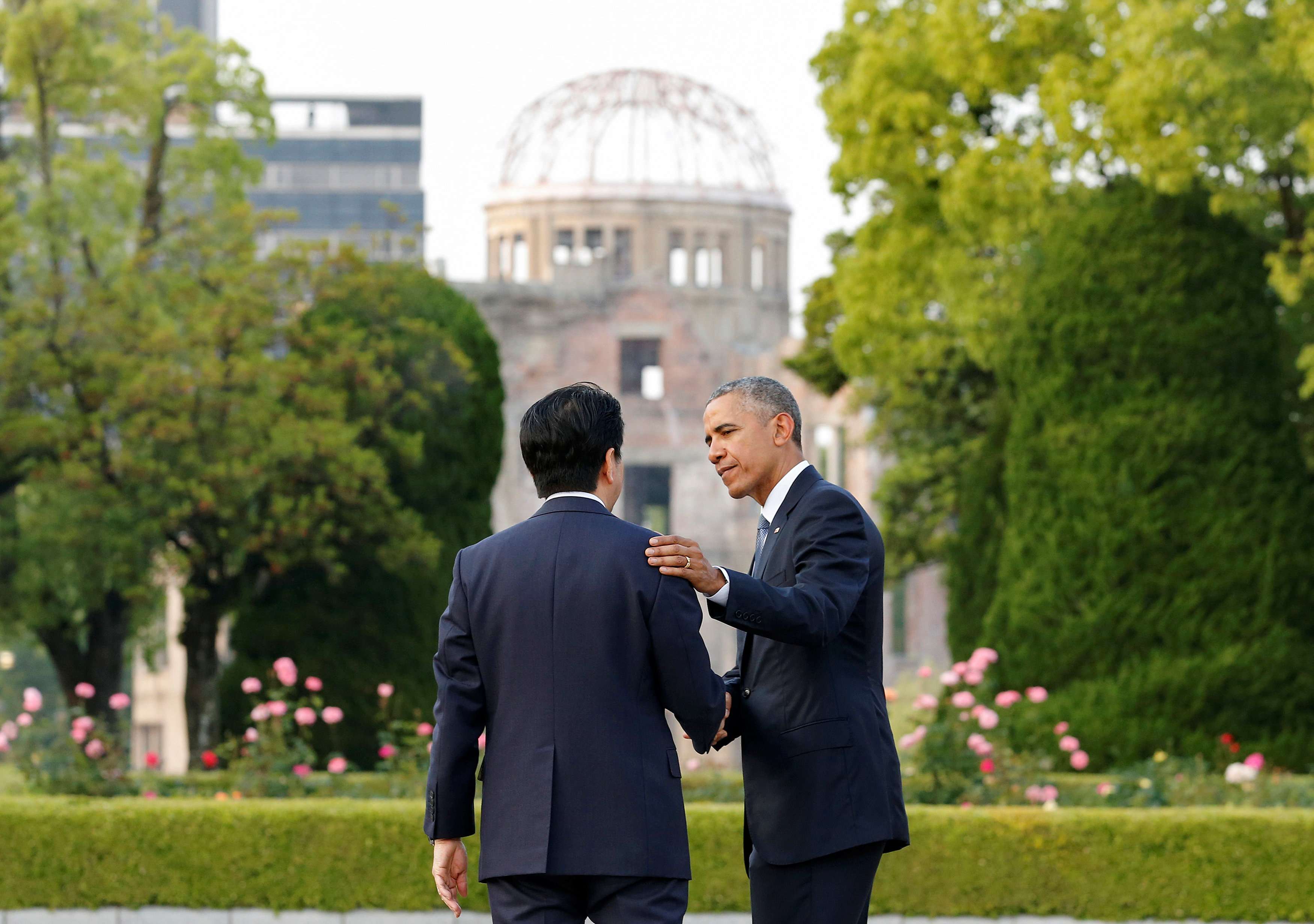 US President Barack Obama shares a poignant moment with Japanese Prime Minister Shinzo Abe after they laid wreaths in front of a cenotaph, with the atomic bomb dome in the background, at Hiroshima Peace Memorial Park. Photo: Reuters
