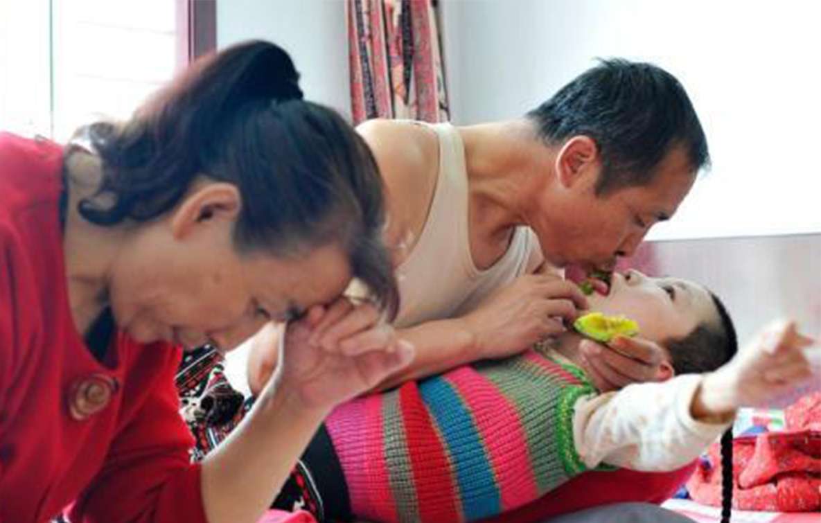 Adoptive parents Zhao Yuchun (right) and his wife Li Huanmei with their adopted autistic daughter, Zhao Likun, aged 15. Photo: SCMP Pictures
