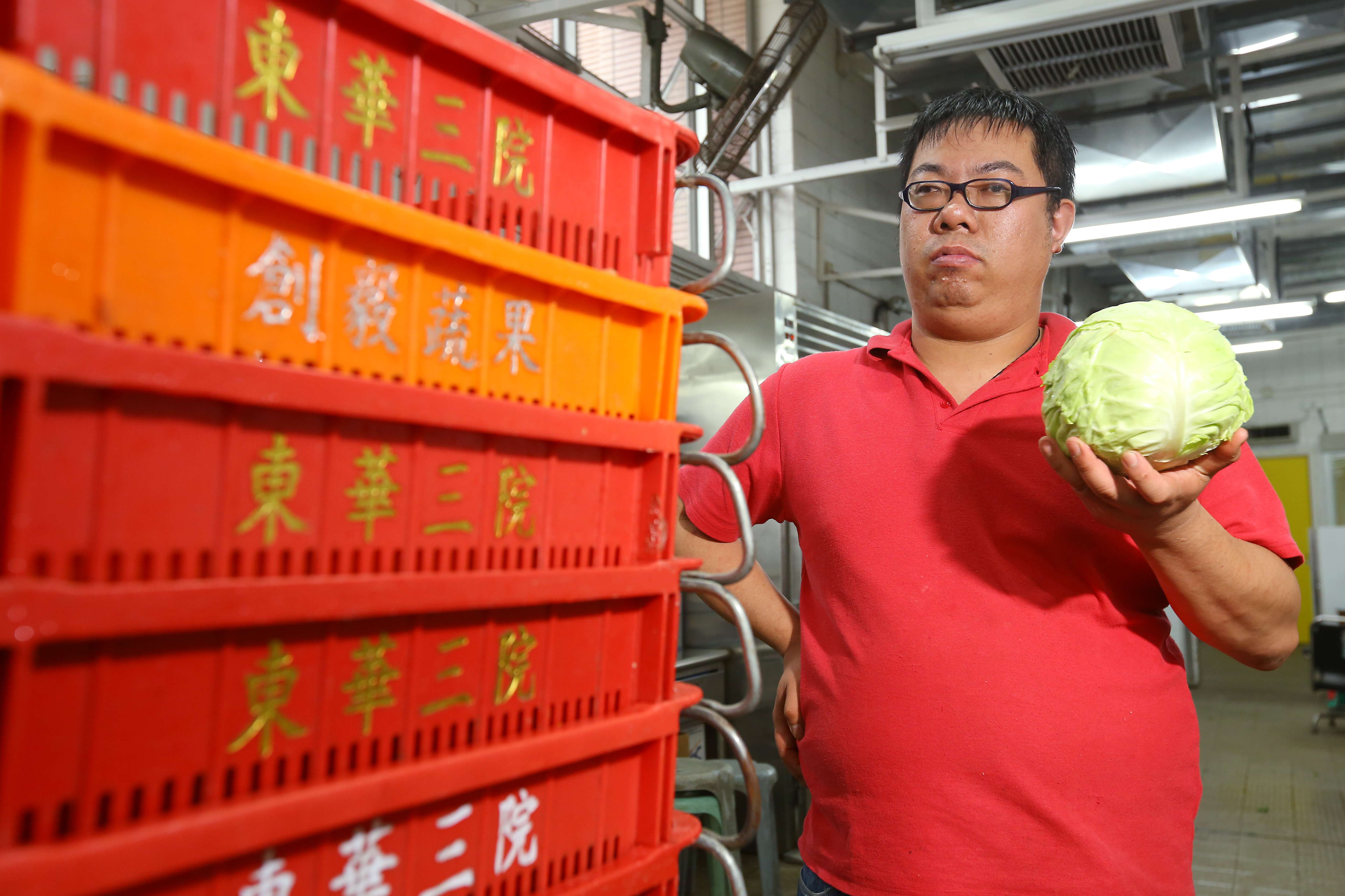Lee Kwong-tak shows off a cabbage at the Jockey Club rehabilitation complex in Aberdeen. Photo: Edmond So