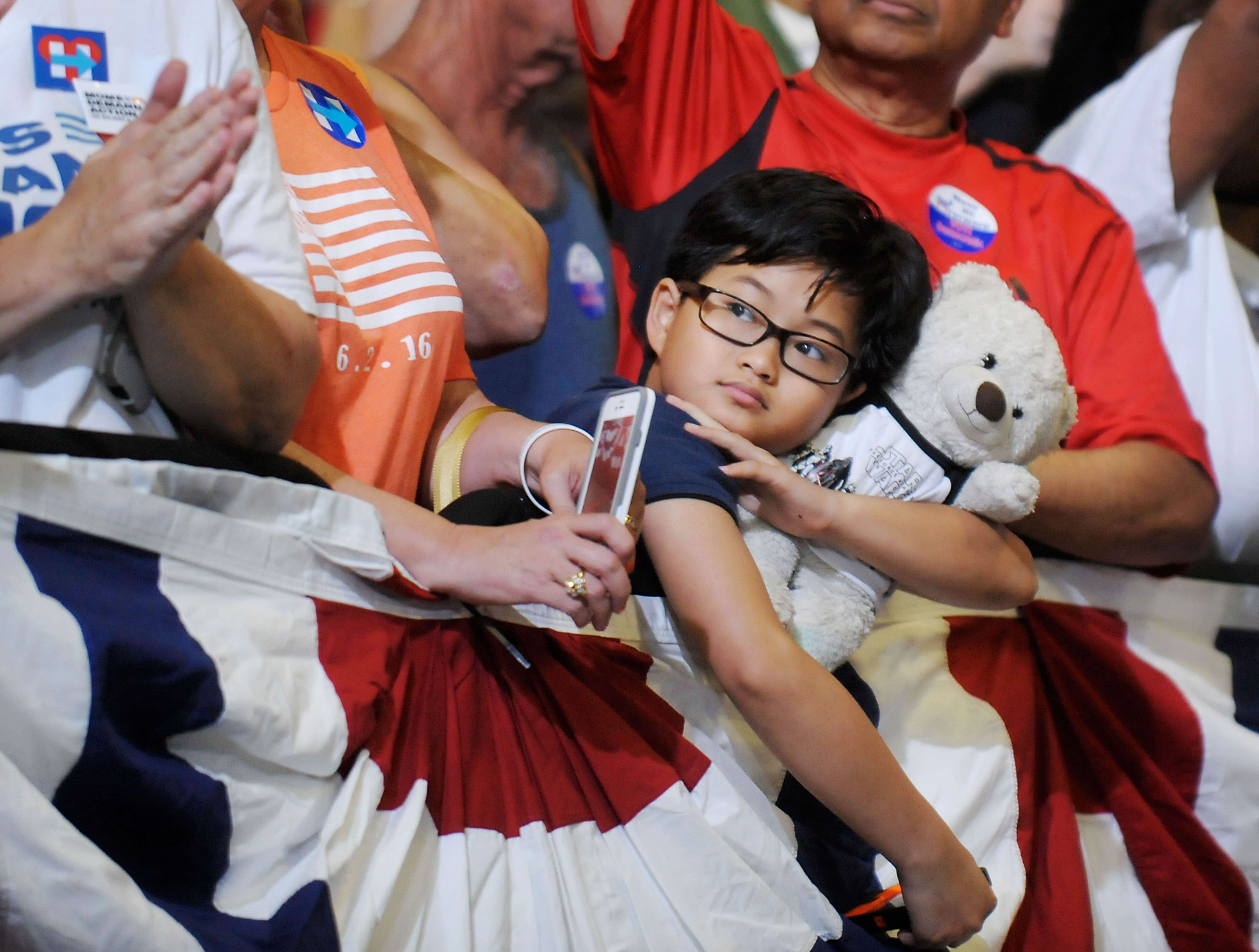 A young supporter awaits the arrival of presumptive Democratic presidential nominee Hillary Clinton at an event in Raleigh, North Carolina. Only 57.5 per cent of the 218 million Americans eligible to vote actually cast their ballot in the 2012 presidential election. Photo: AFP