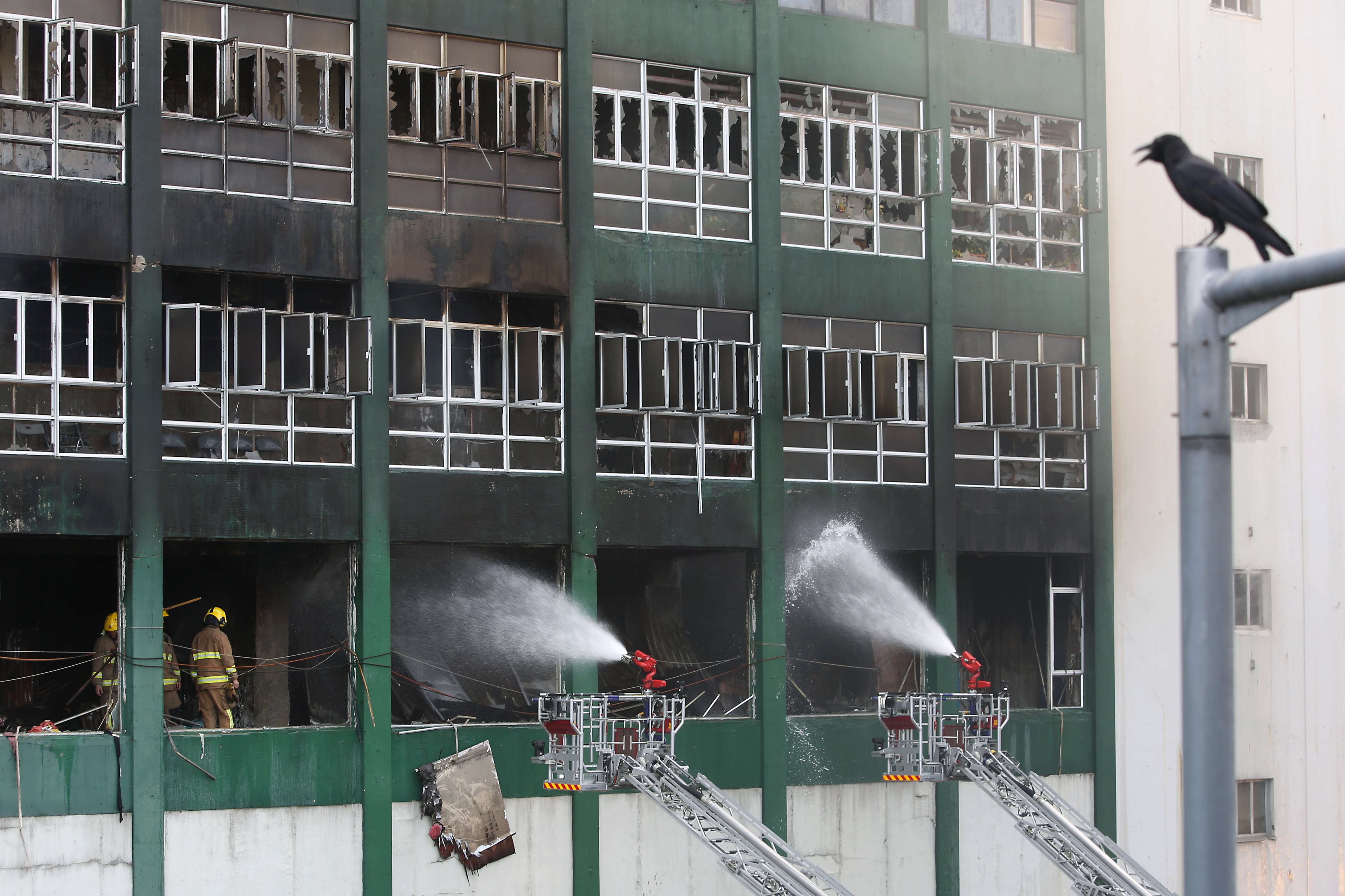 The firefighters have had to knock down each individual door of about 200 cubicles, separated by metal sheets, to inspect what was stored inside. Photo: Sam Tsang