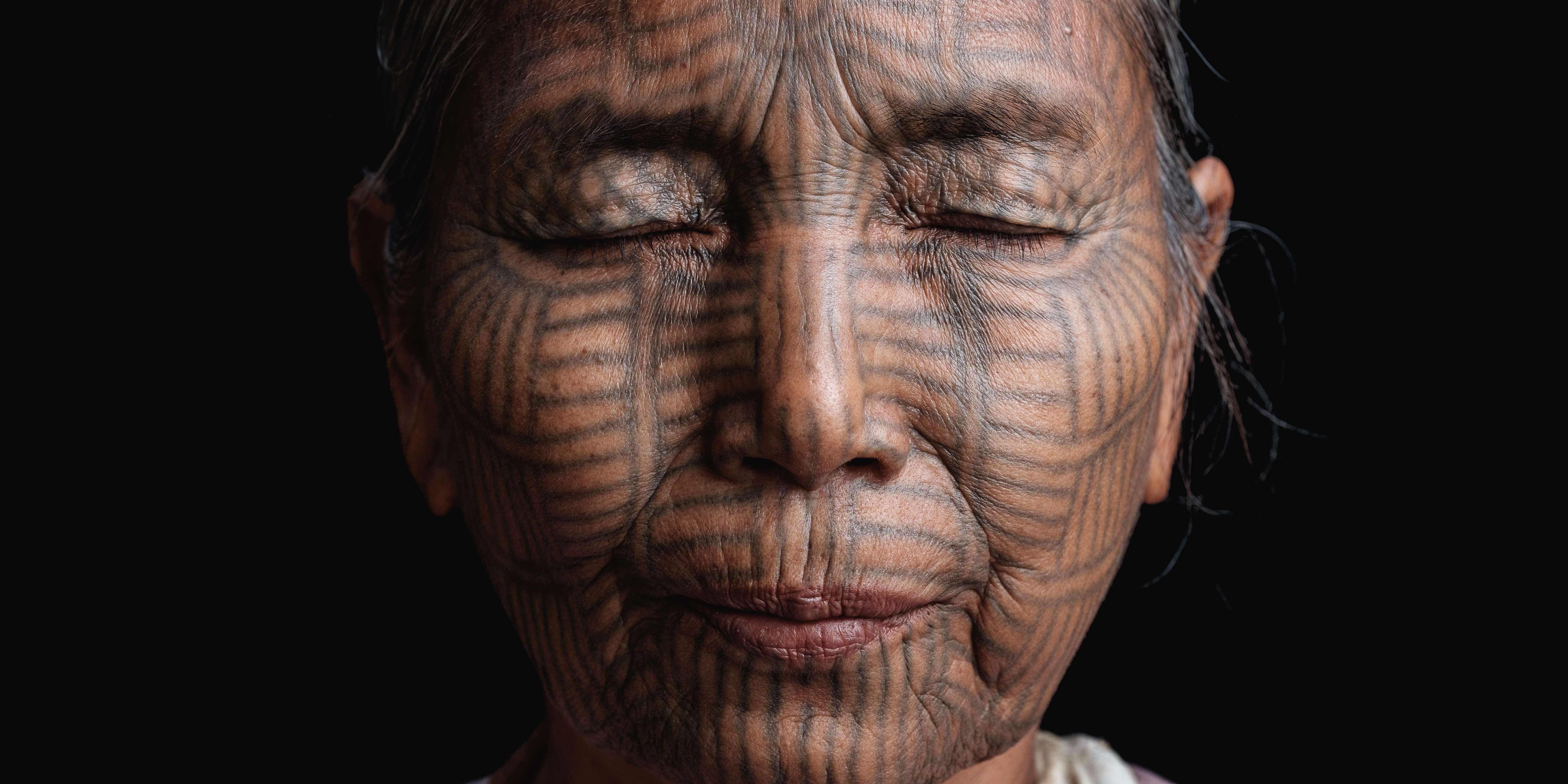 Bant Tone was nine years old when she was tattooed, and clearly remembers the pain of the day. She thought she was exceptionally pretty after she got her tattoo, and was pleased that she was now considered a woman. She also felt pride, as the other peoples of Myanmar were envious of her tribe’s tattooed faces. Photos: Dylan Goldby
