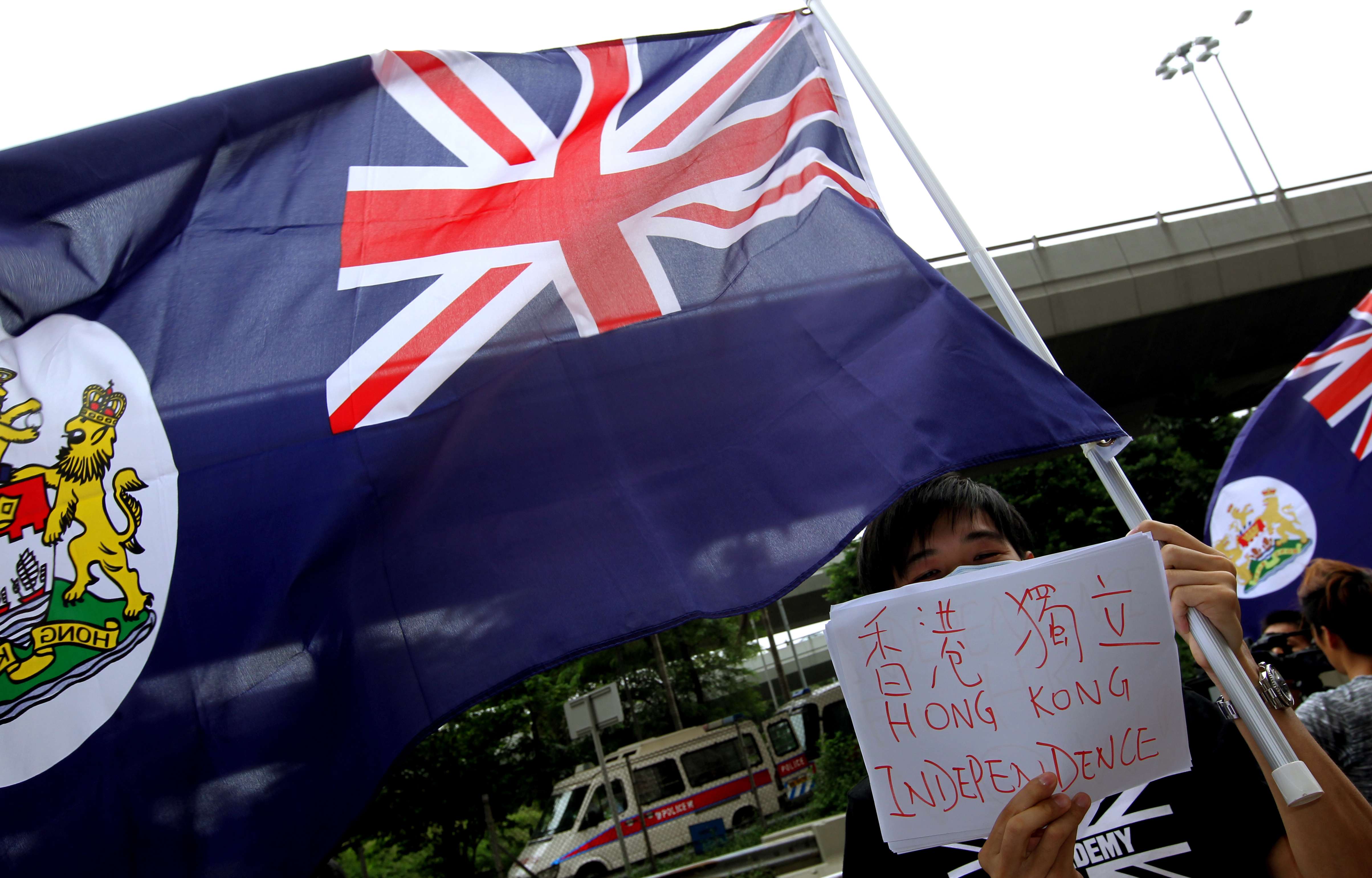 Hong Kong localists wave the colonial-era flag in front of the central government's liaison office in Western District. Photo: Dickson Lee
