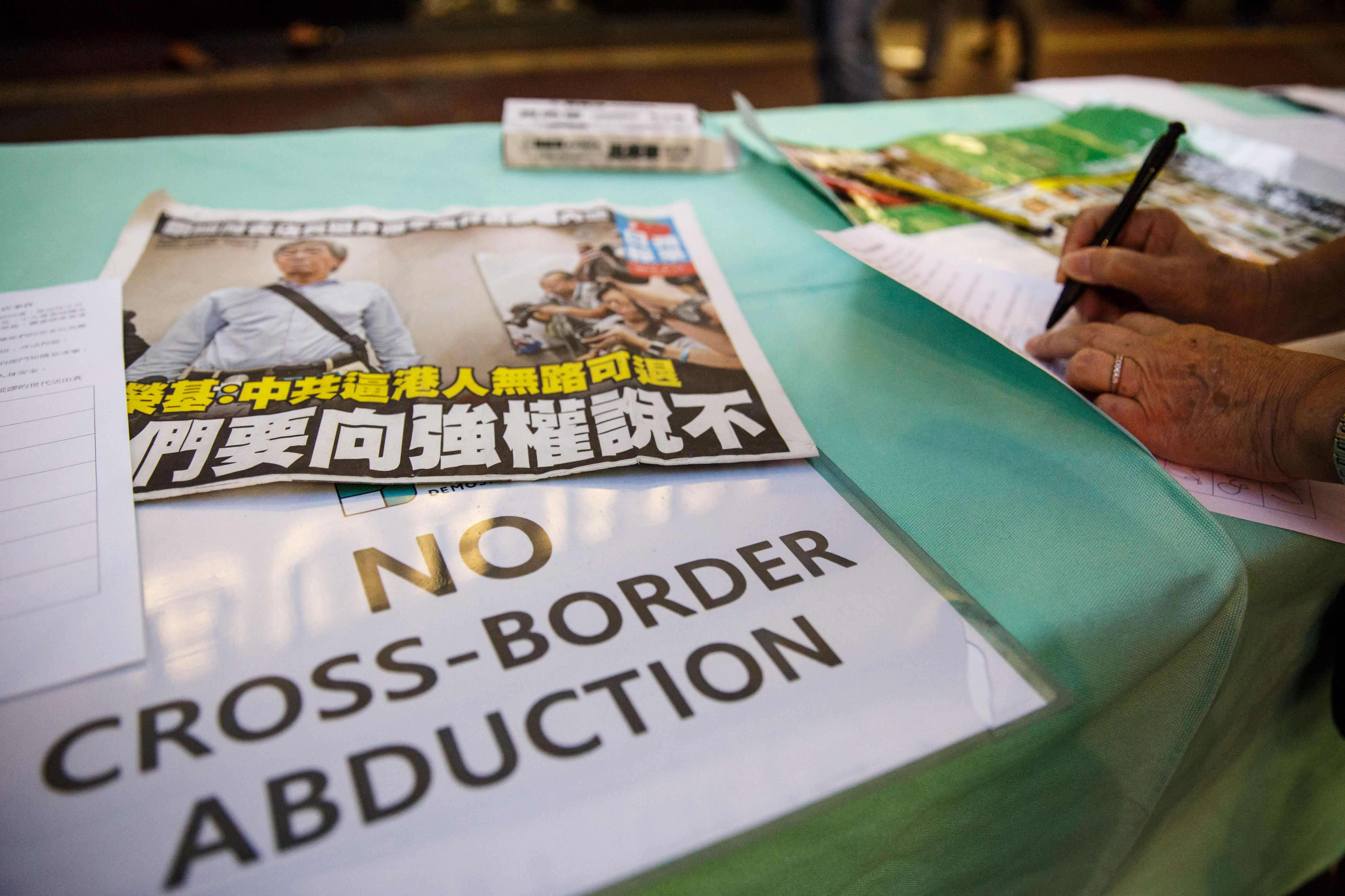 A placard displayed next to a petition set up by pro-democracy political group Demosisto in support of freedom of press and speech and for the missing and returned booksellers outside the Causeway Bay Books store in Hong Kong. Photo: AFP