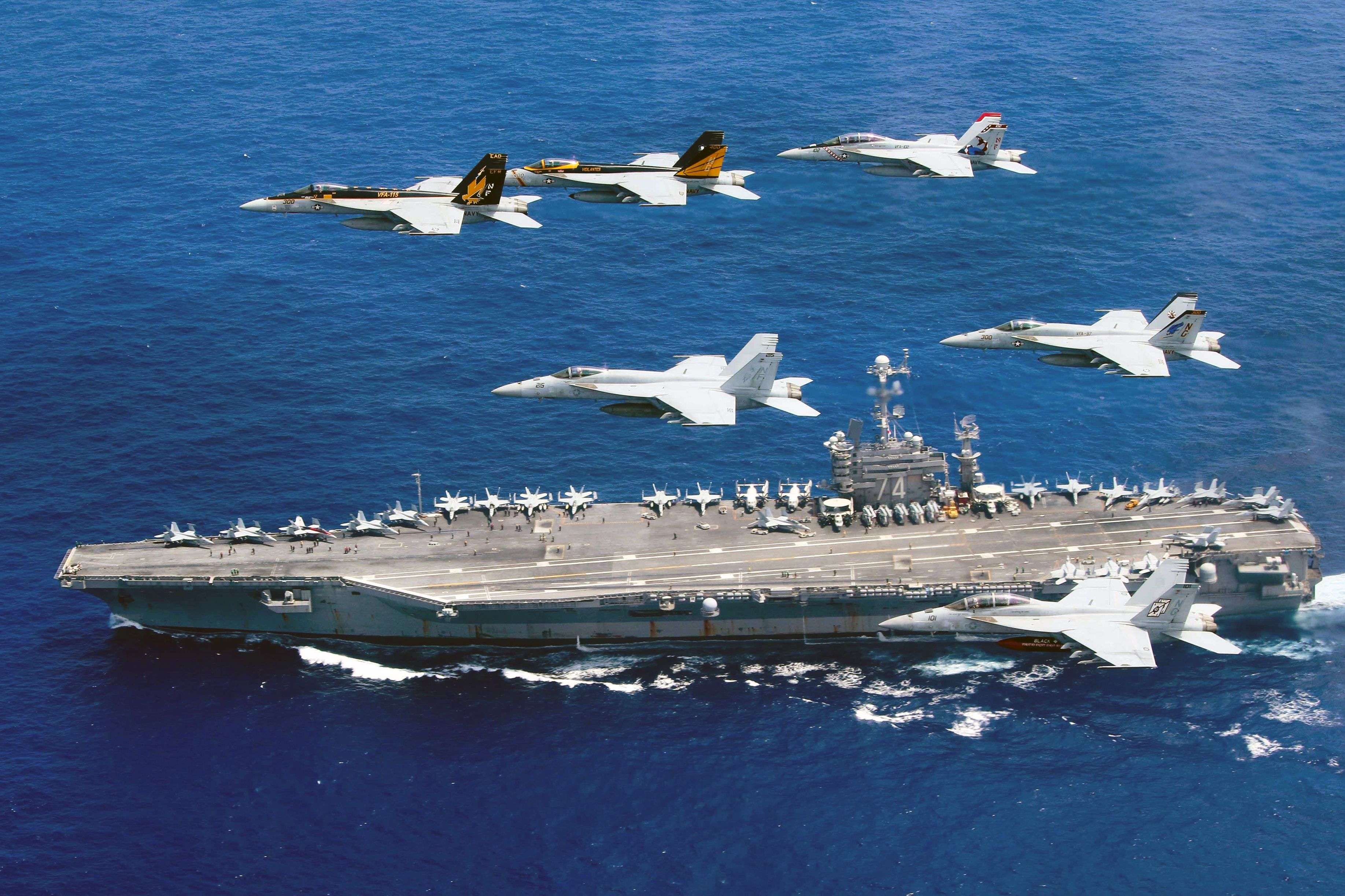 US fighter planes fly above the Nimitz-class aircraft carrier USS John C. Stennis in the Philippine Sea. Two US aircraft carriers have started exercises in the area, defence officials said on June 19, as Washington's ally Manila faces growing pressure from Beijing in the South China Sea. Photo: AFP